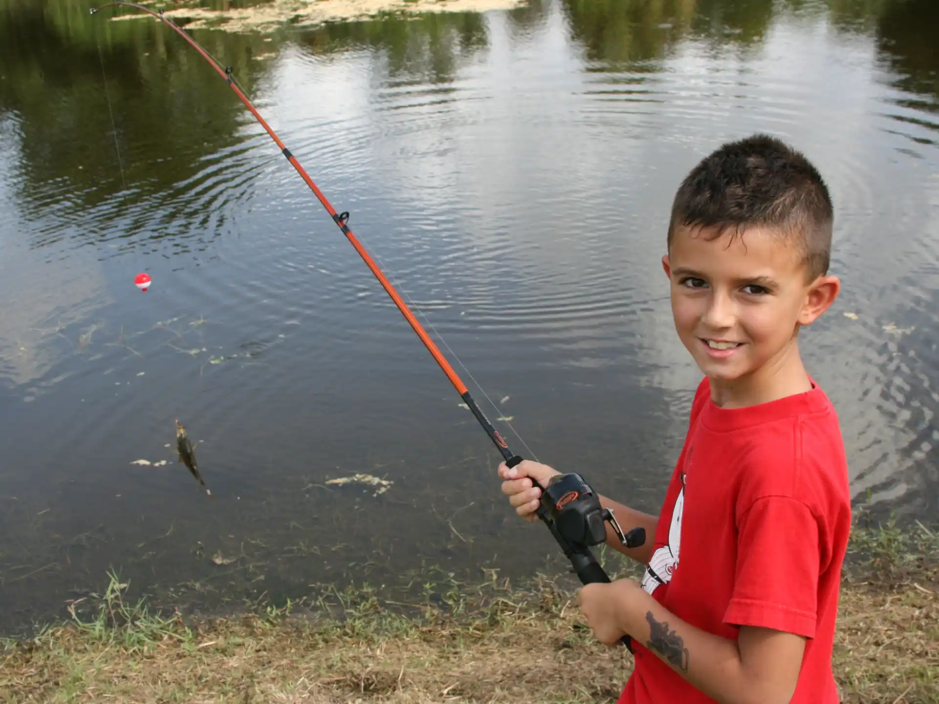 a boy holding a fishing pole