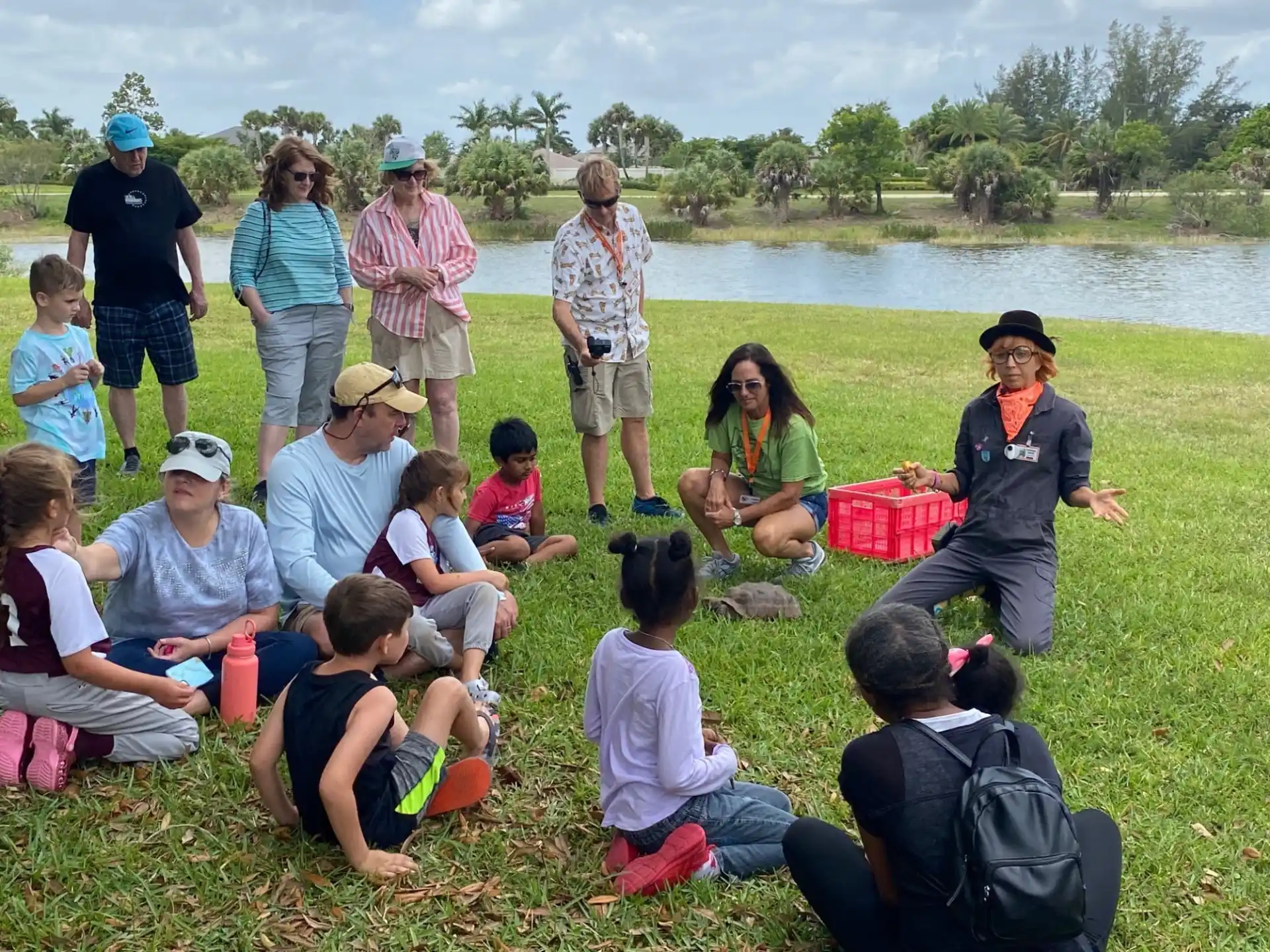a group of people sitting on the grass