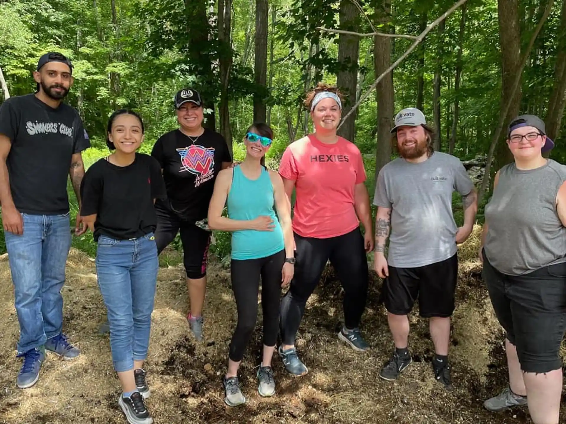 a group of people posing for a photo in the woods