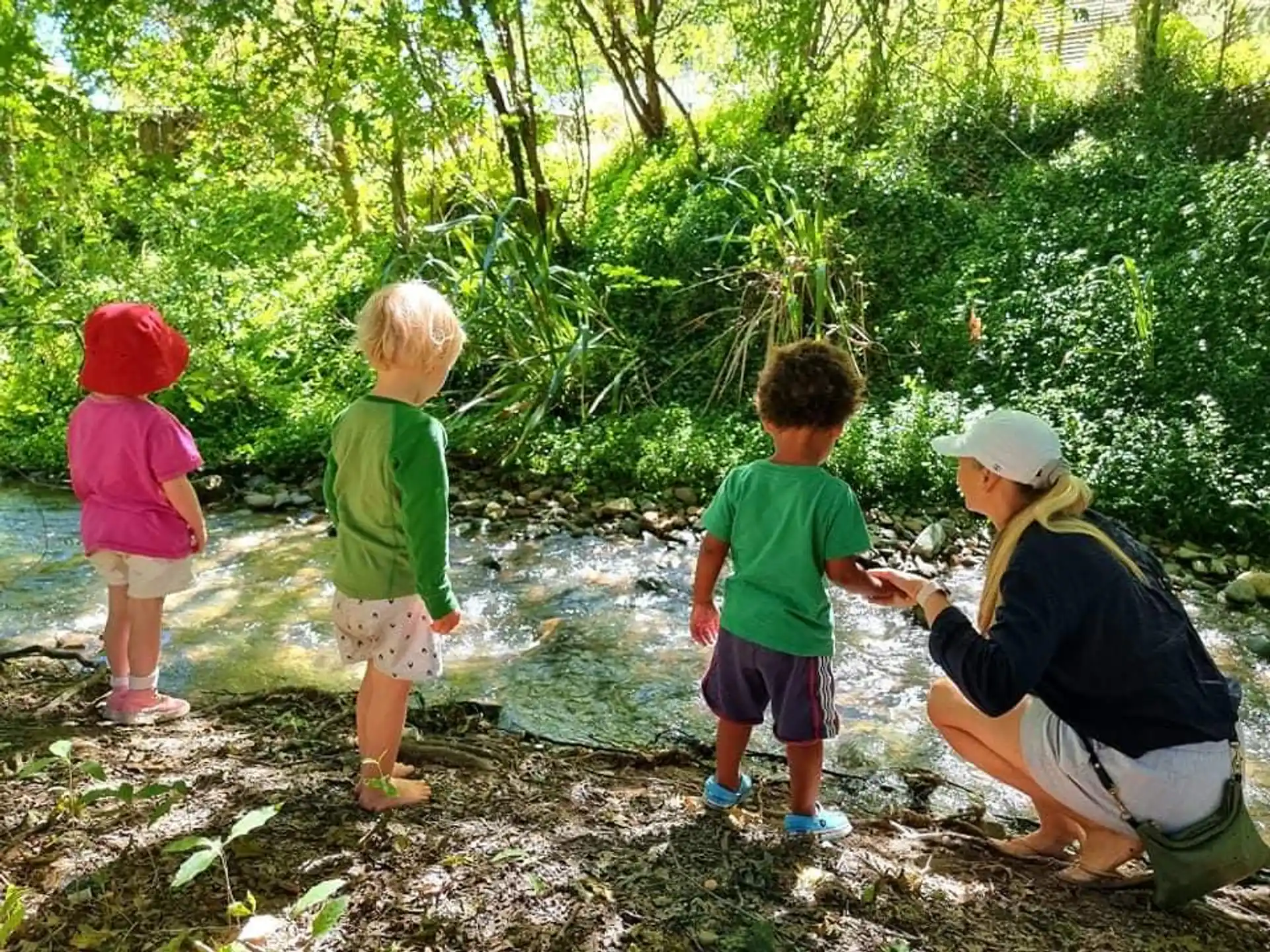 a person and two children in the woods