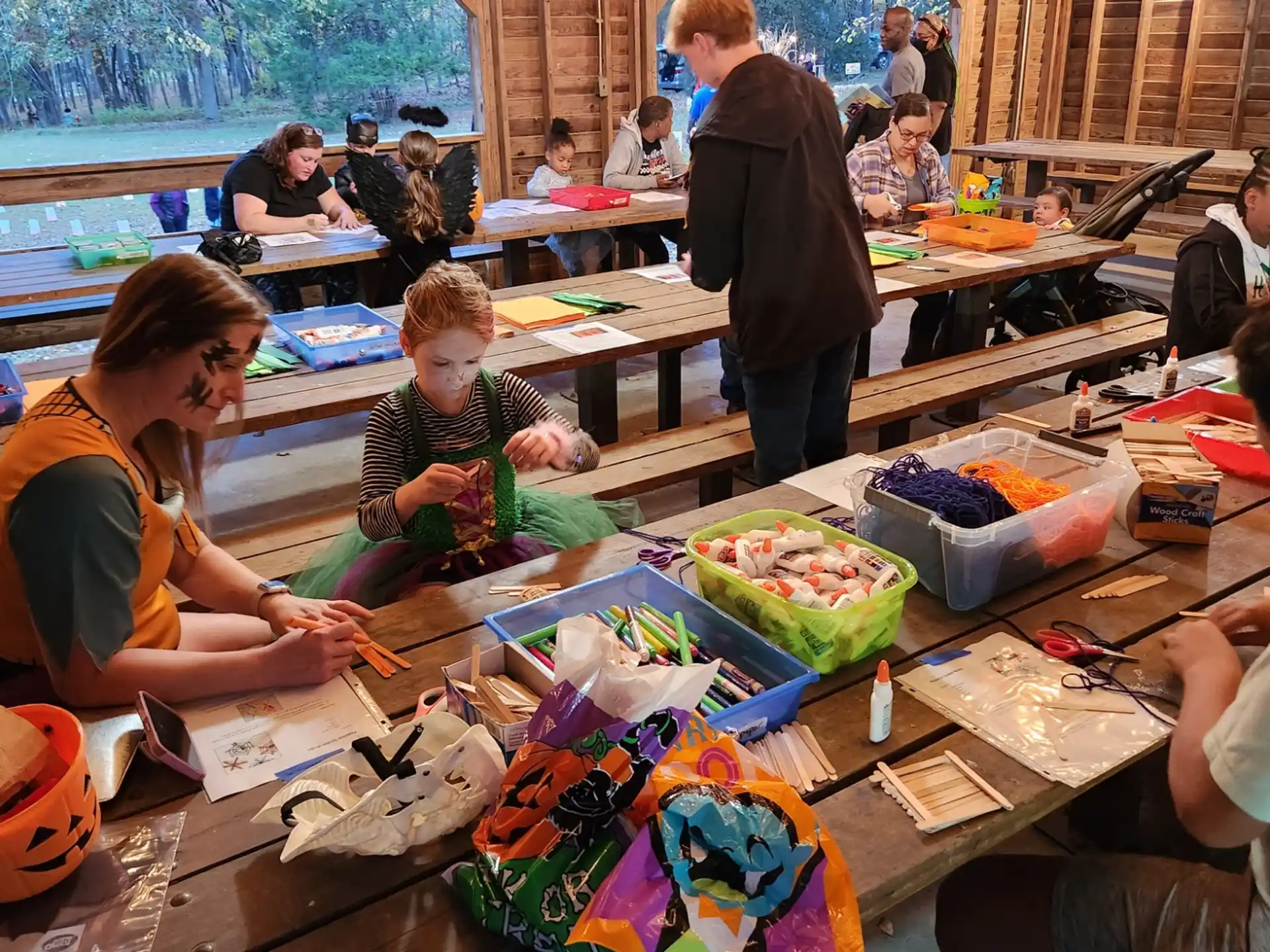 a group of people sitting at a table with lots of items on it