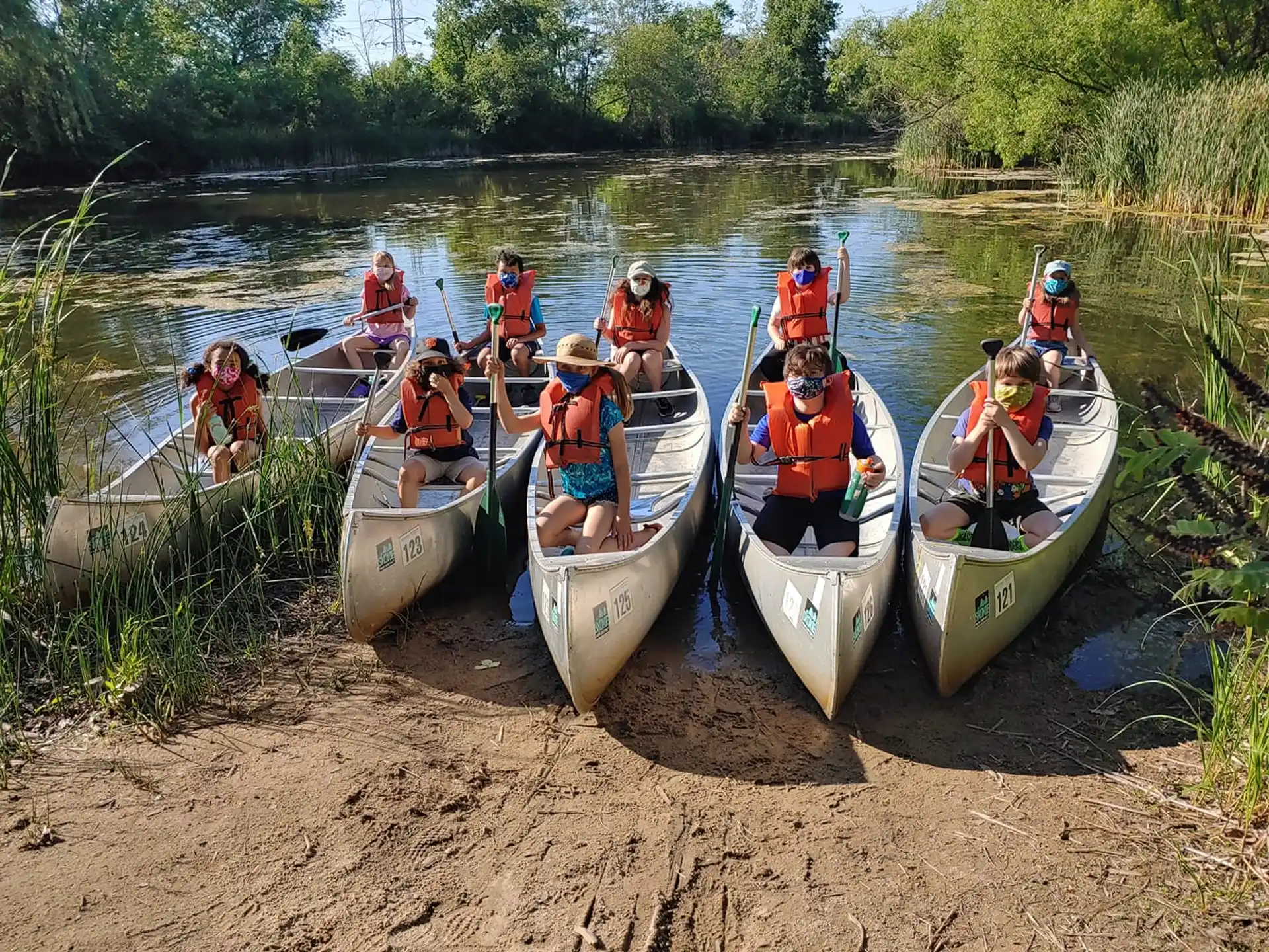 a group of people in canoes on a river