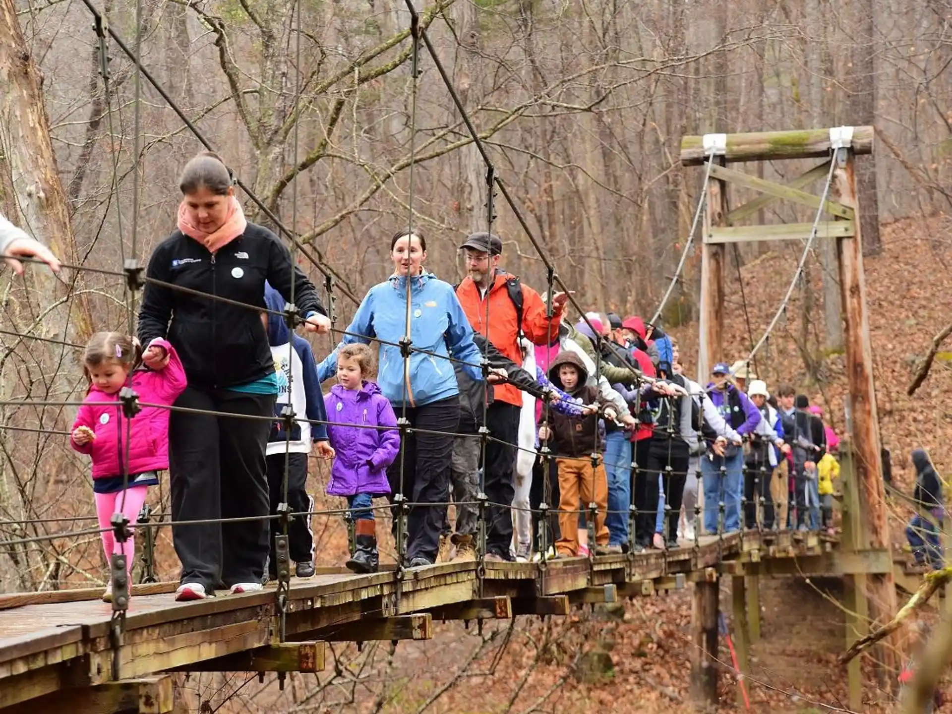 a group of people standing on a bridge