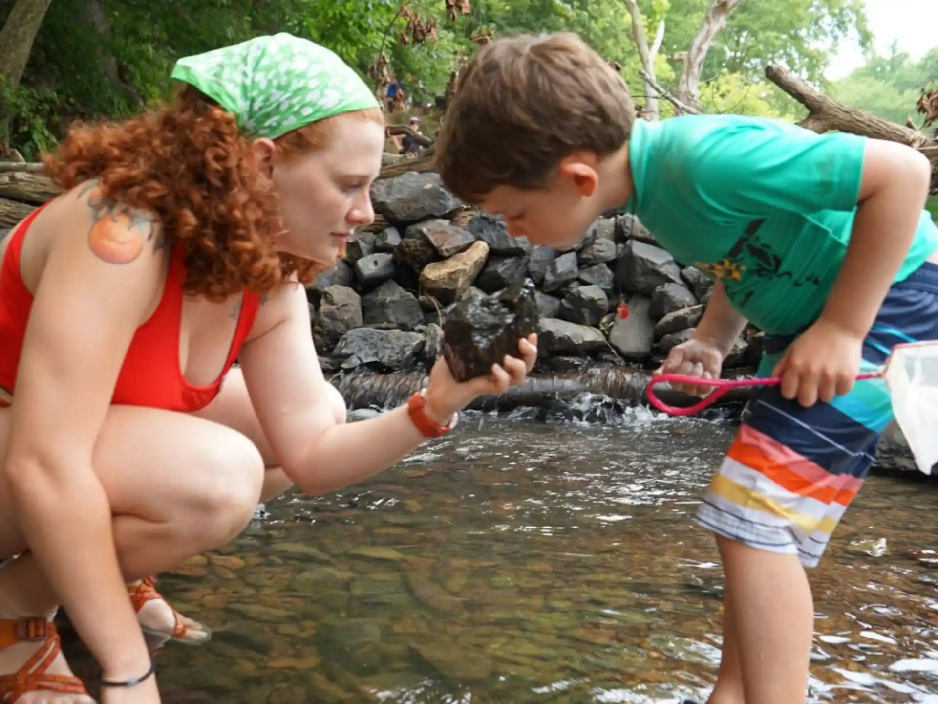 a woman and two children in a stream