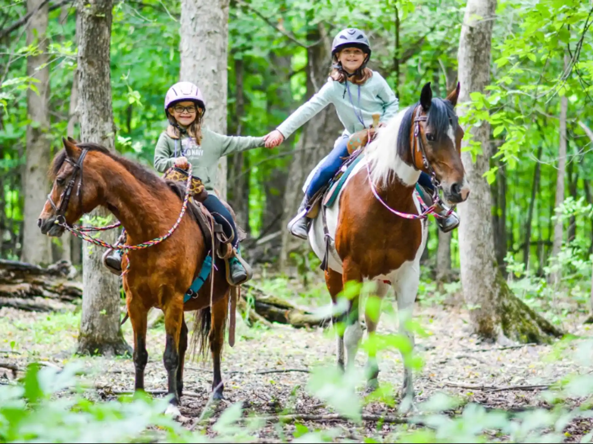 a couple of people riding horses