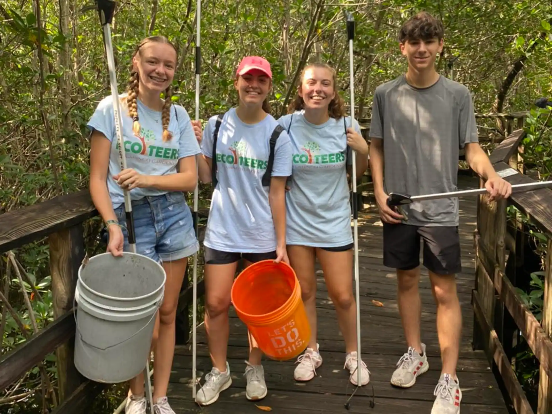 a group of people holding buckets