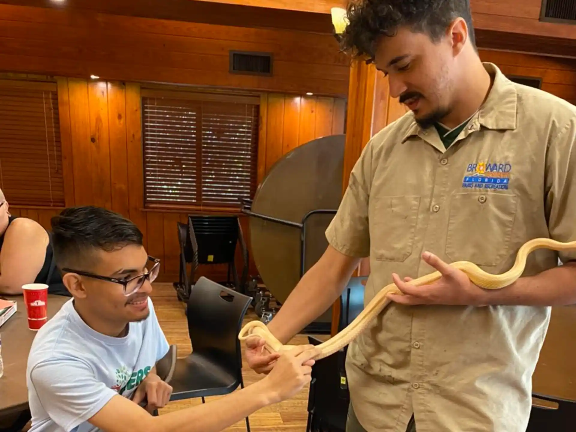 a man holding a large snake