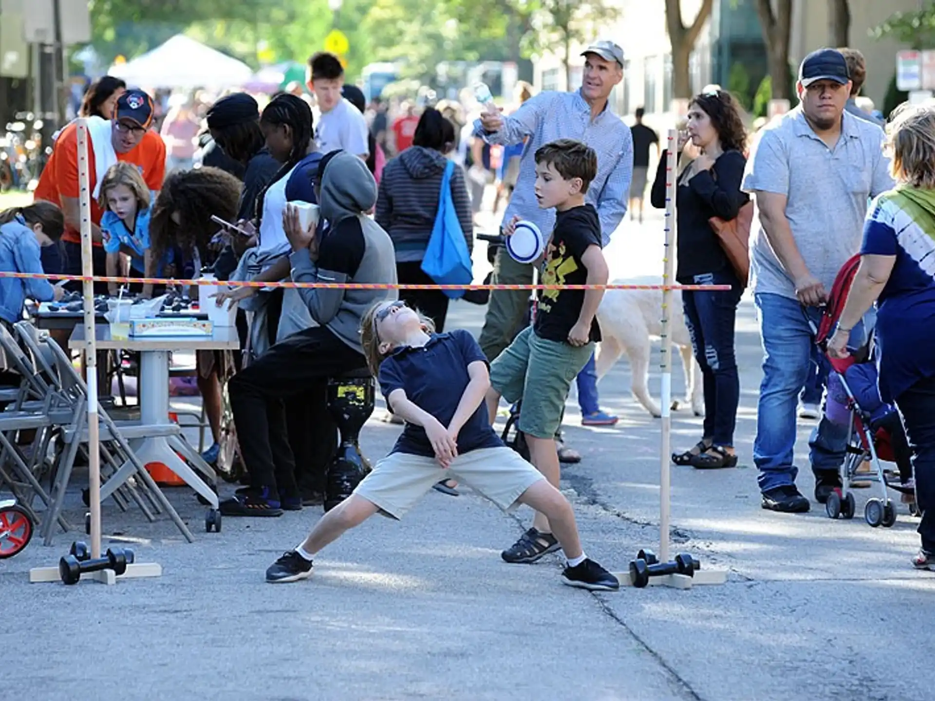 a group of people watching a person do a stunt on a skateboard
