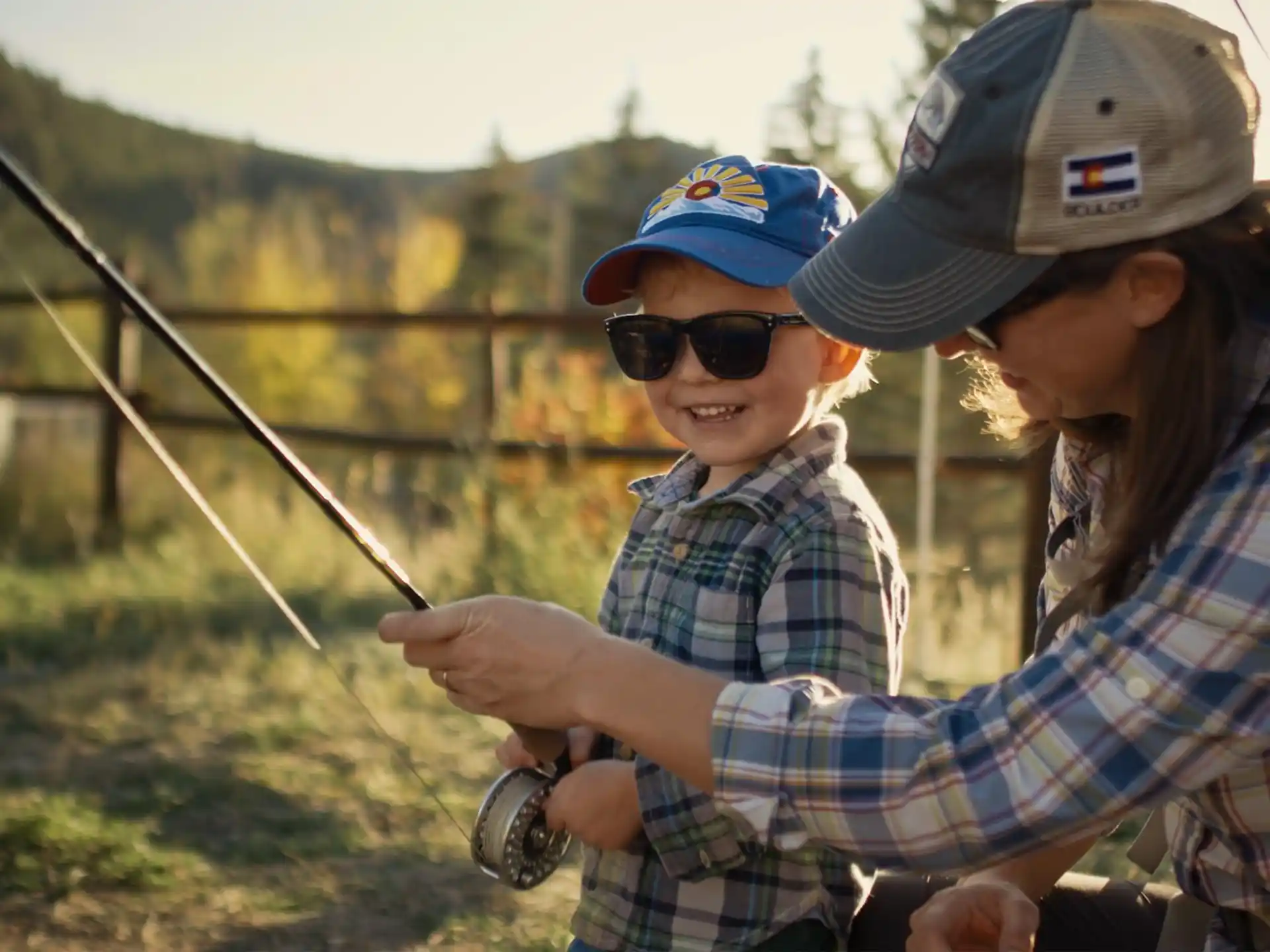 a man and a boy holding a fishing rod