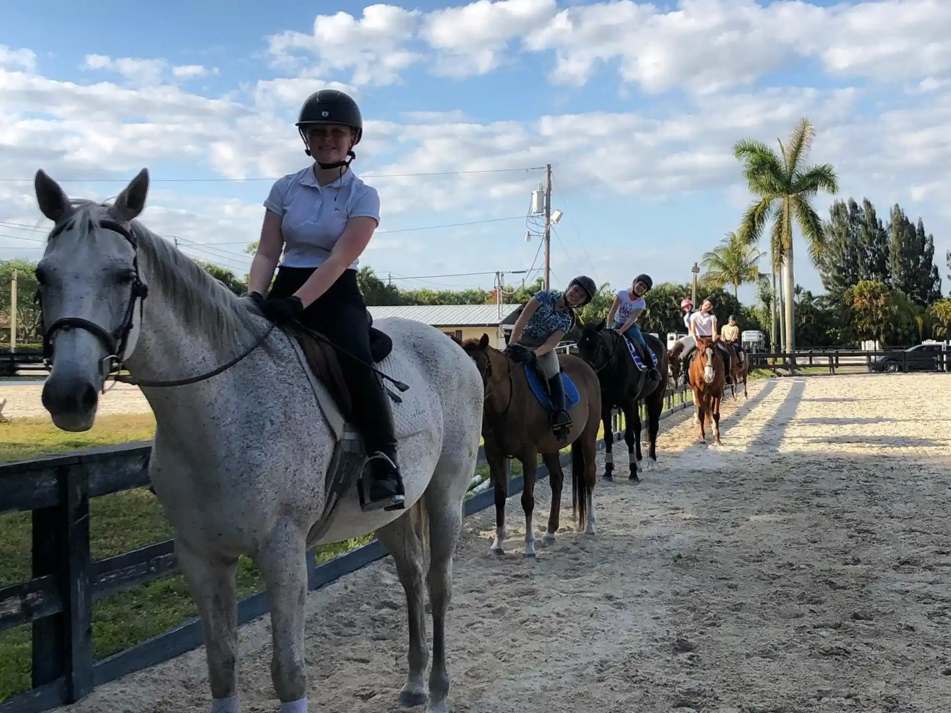 a group of people riding horses