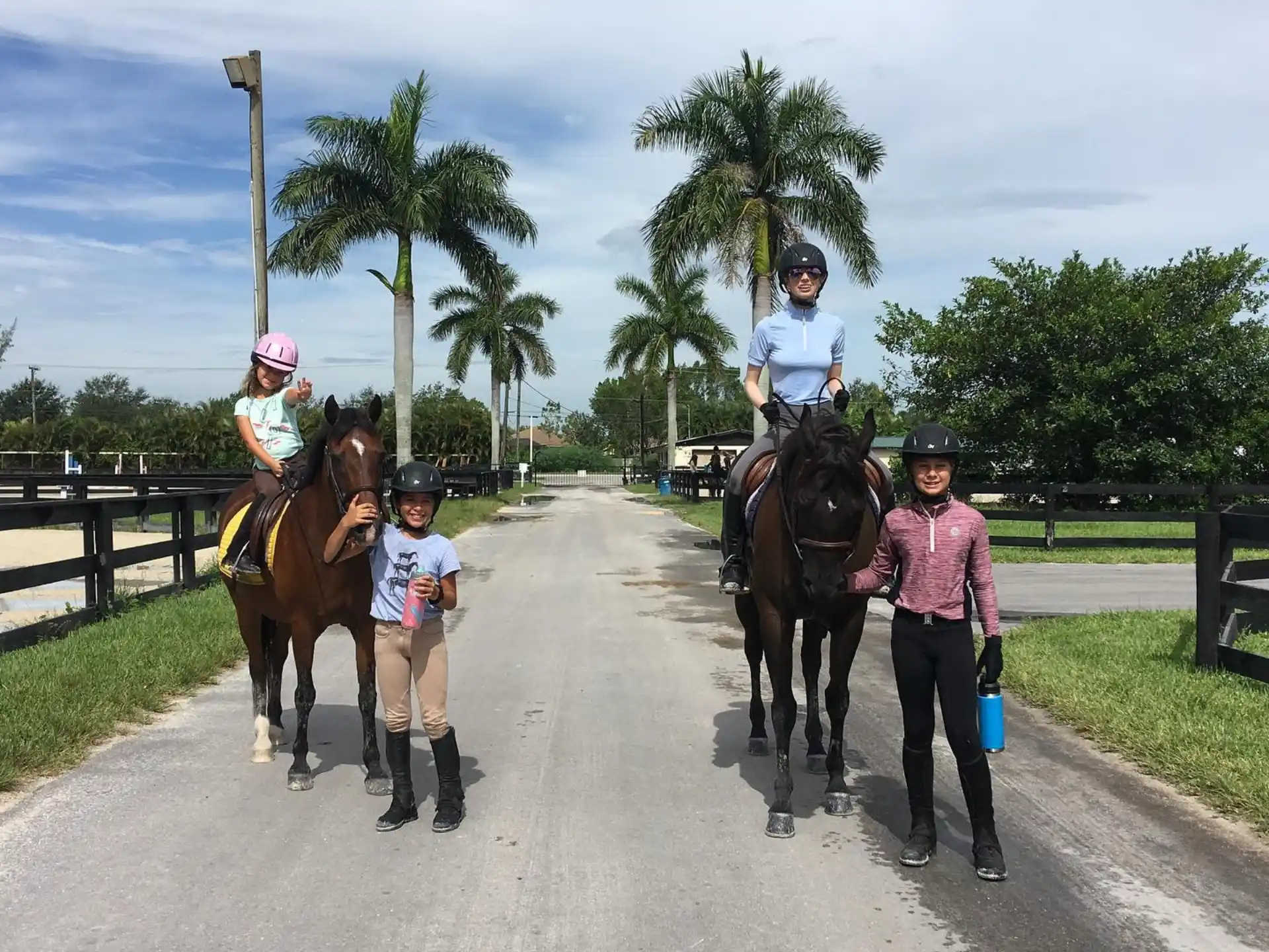 a group of people walking horses