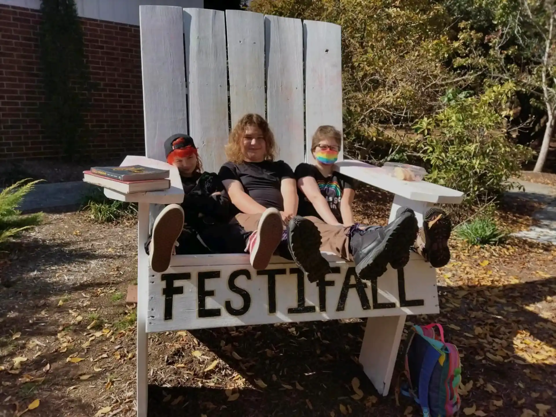 a group of people sitting on a bench outside