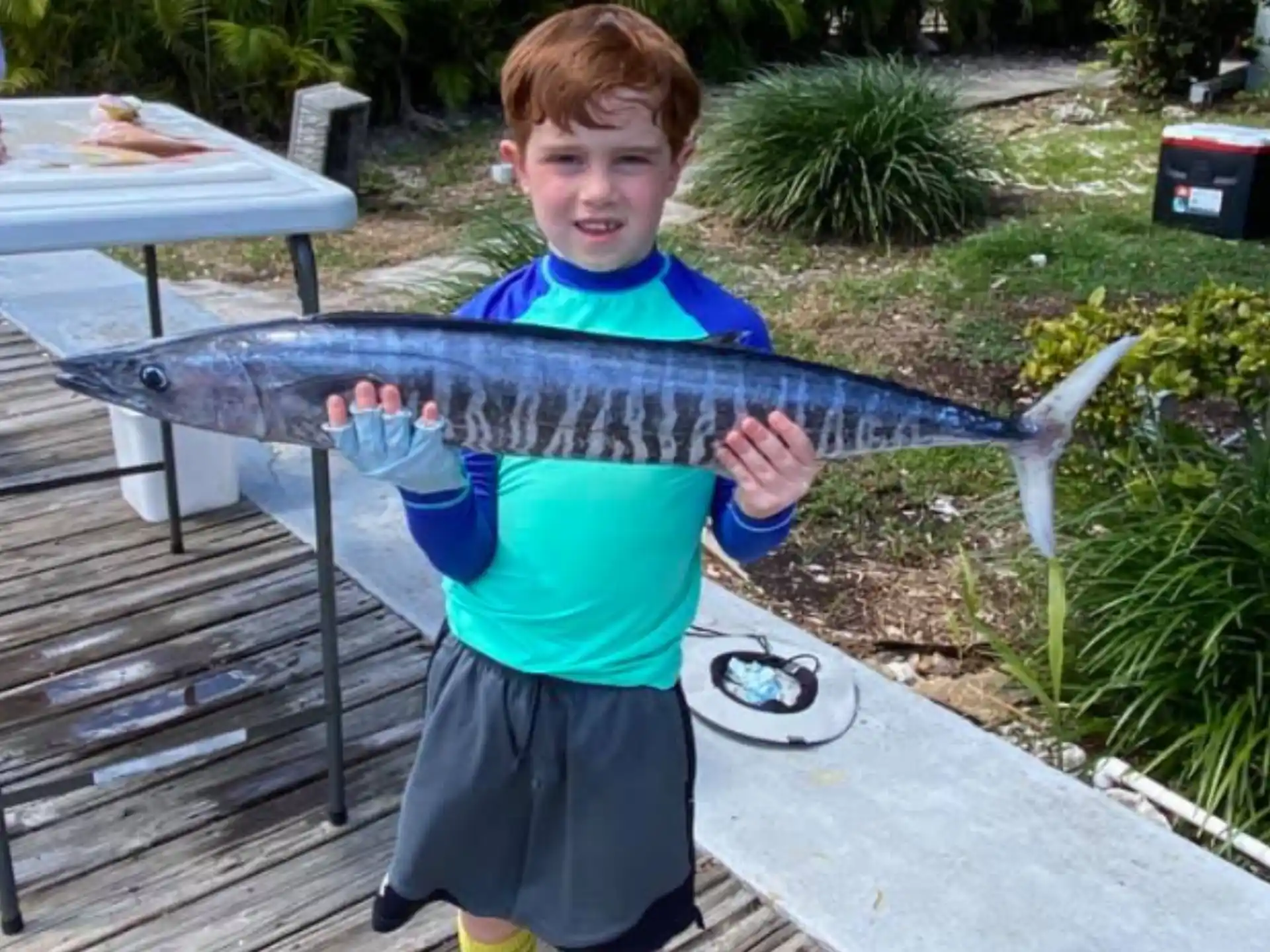 a boy holding a fish