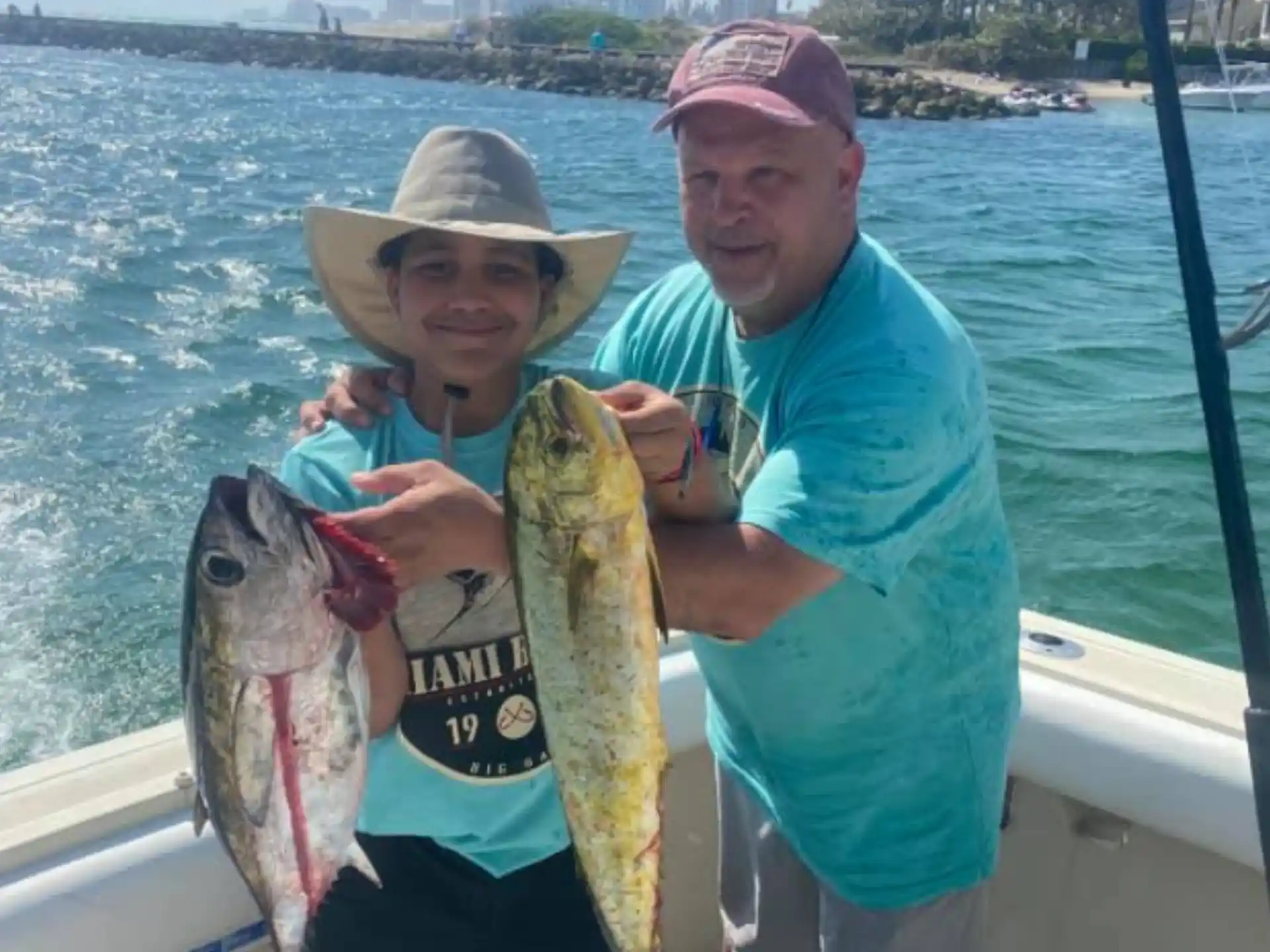 a man and a woman holding a fish on a boat