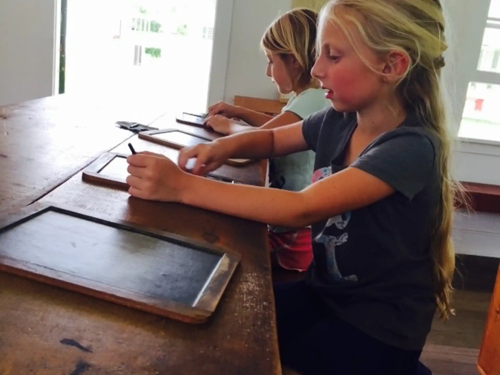 a young girl using a computer