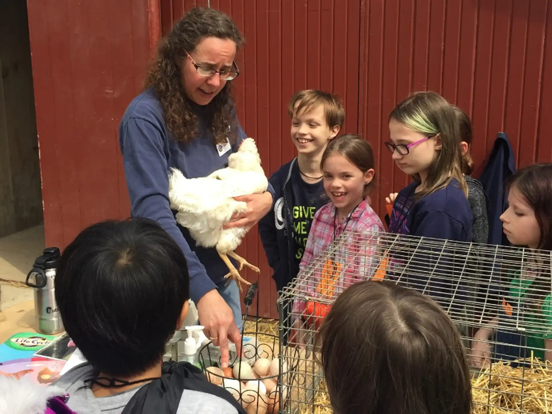 a person holding a stuffed animal with children around the