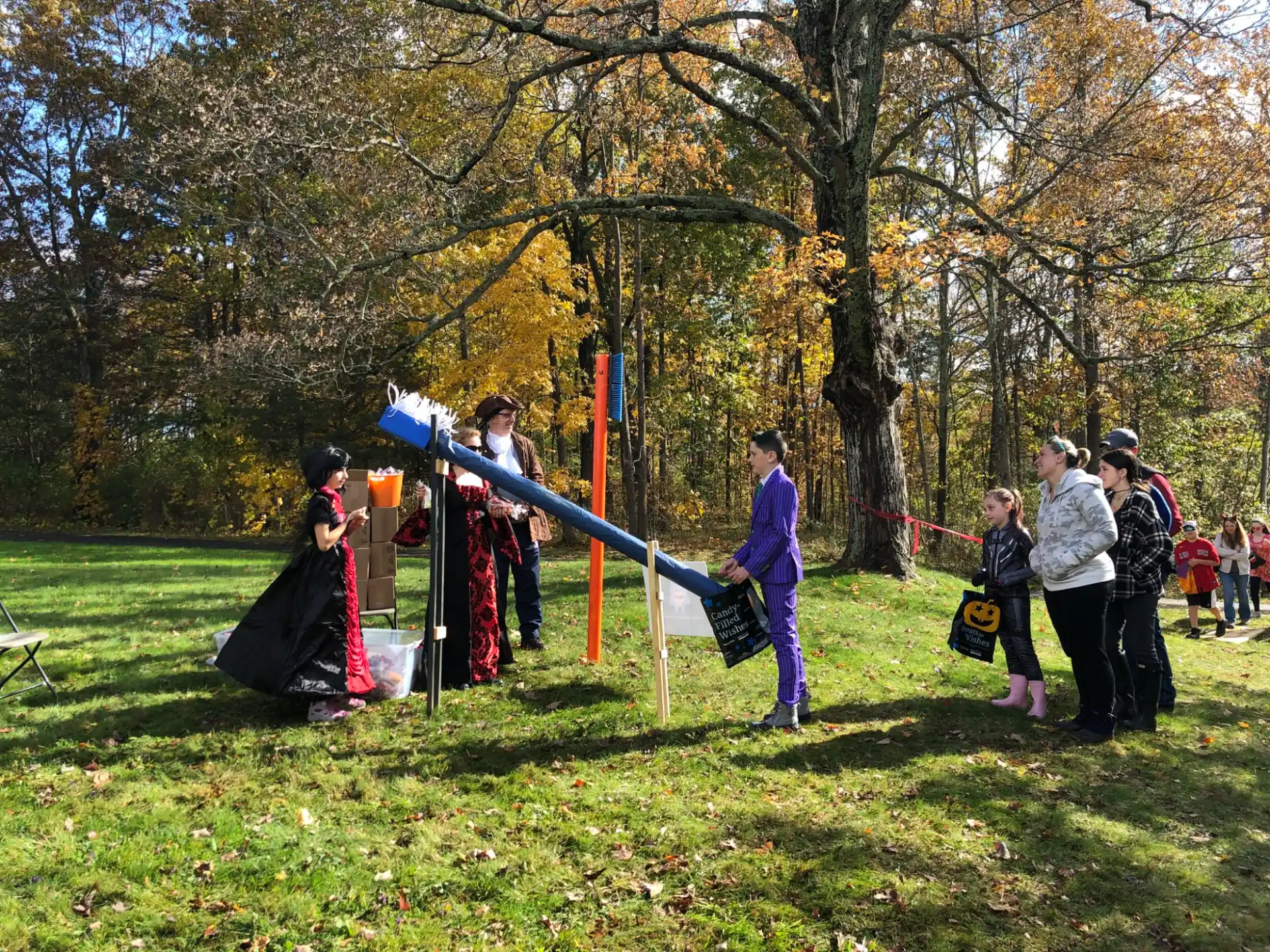 a group of people playing on a swing set in a park