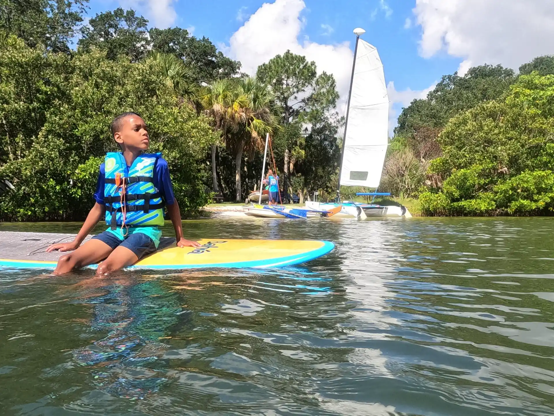 a person sitting on a surfboard