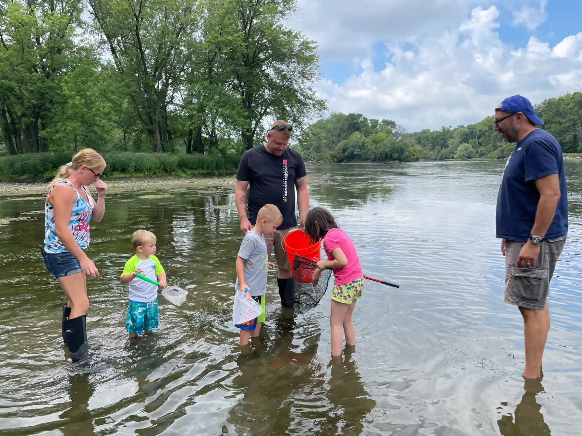 a group of people standing in water