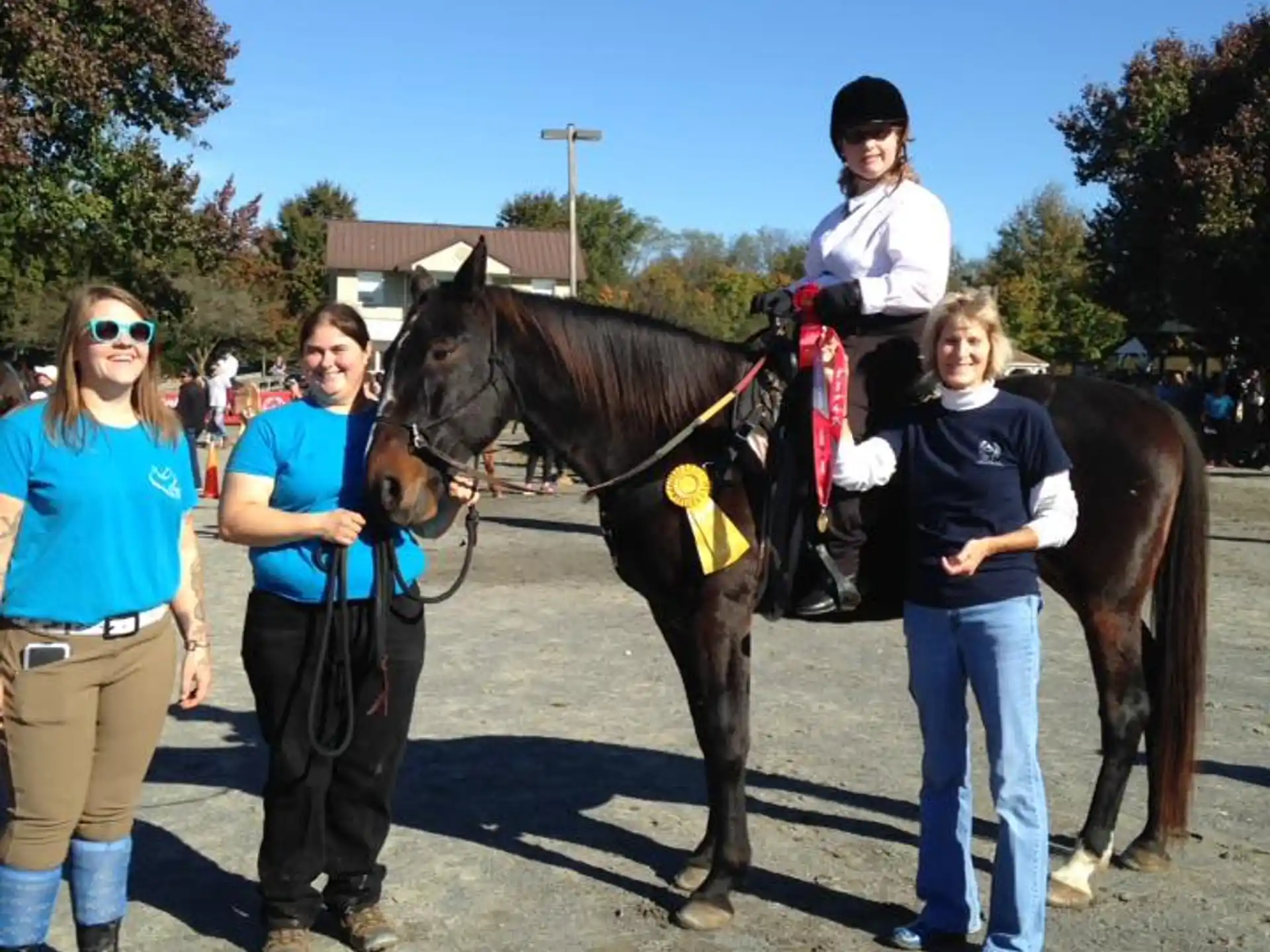 a group of people standing next to a horse