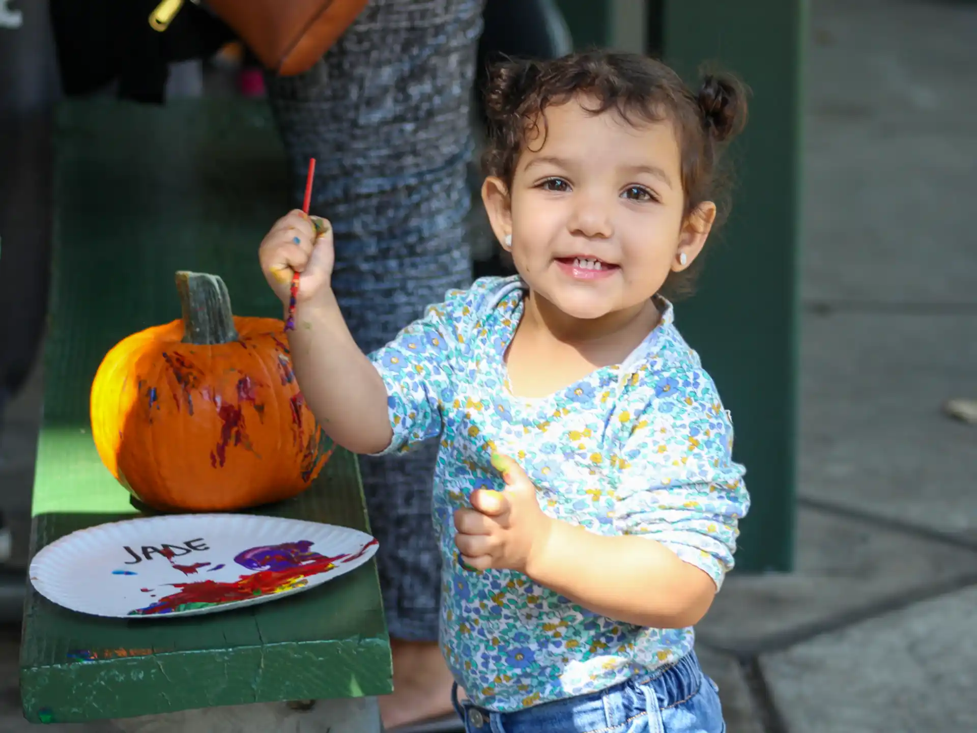 a girl holding a pumpkin