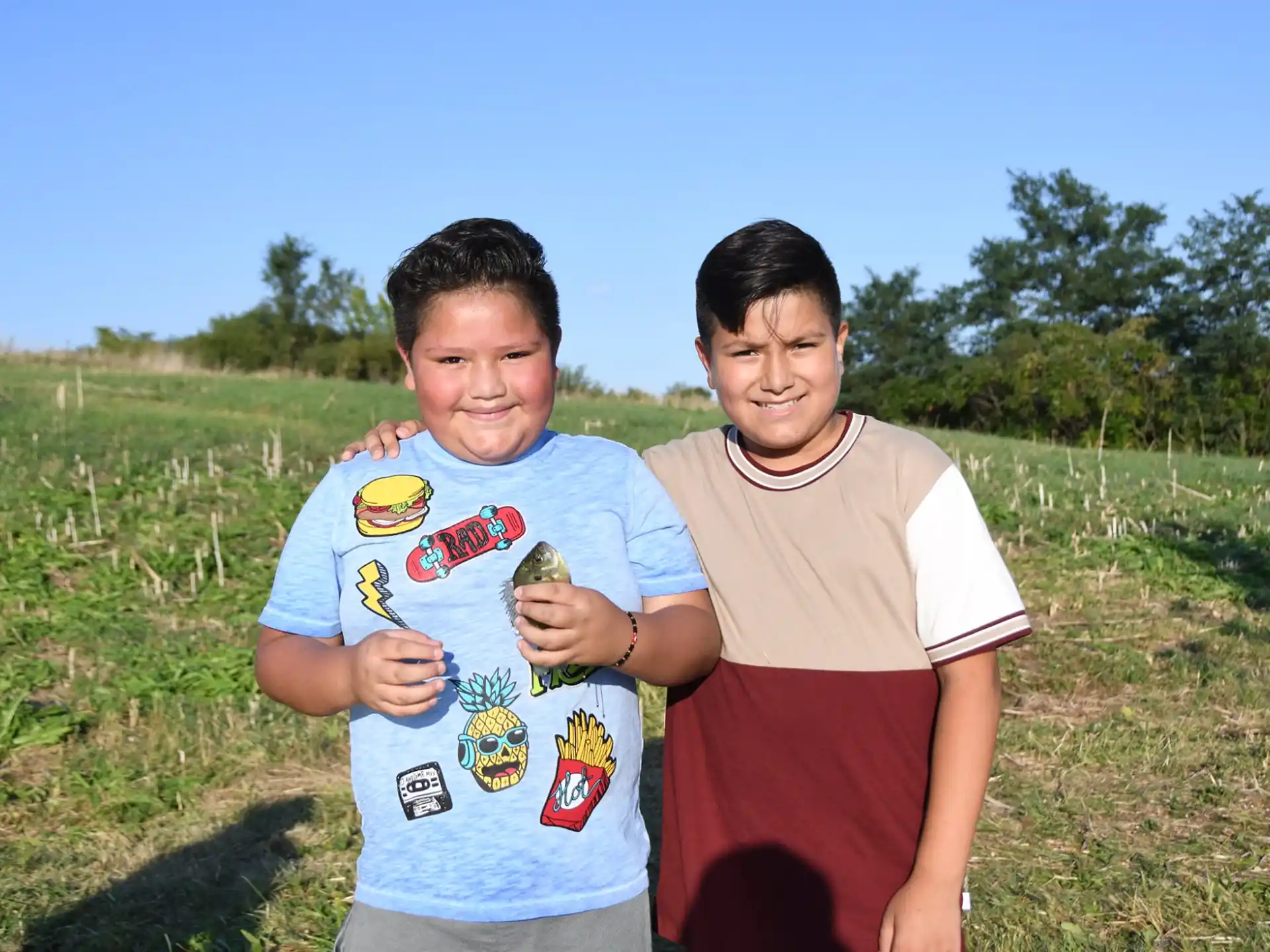 two boys standing in a field
