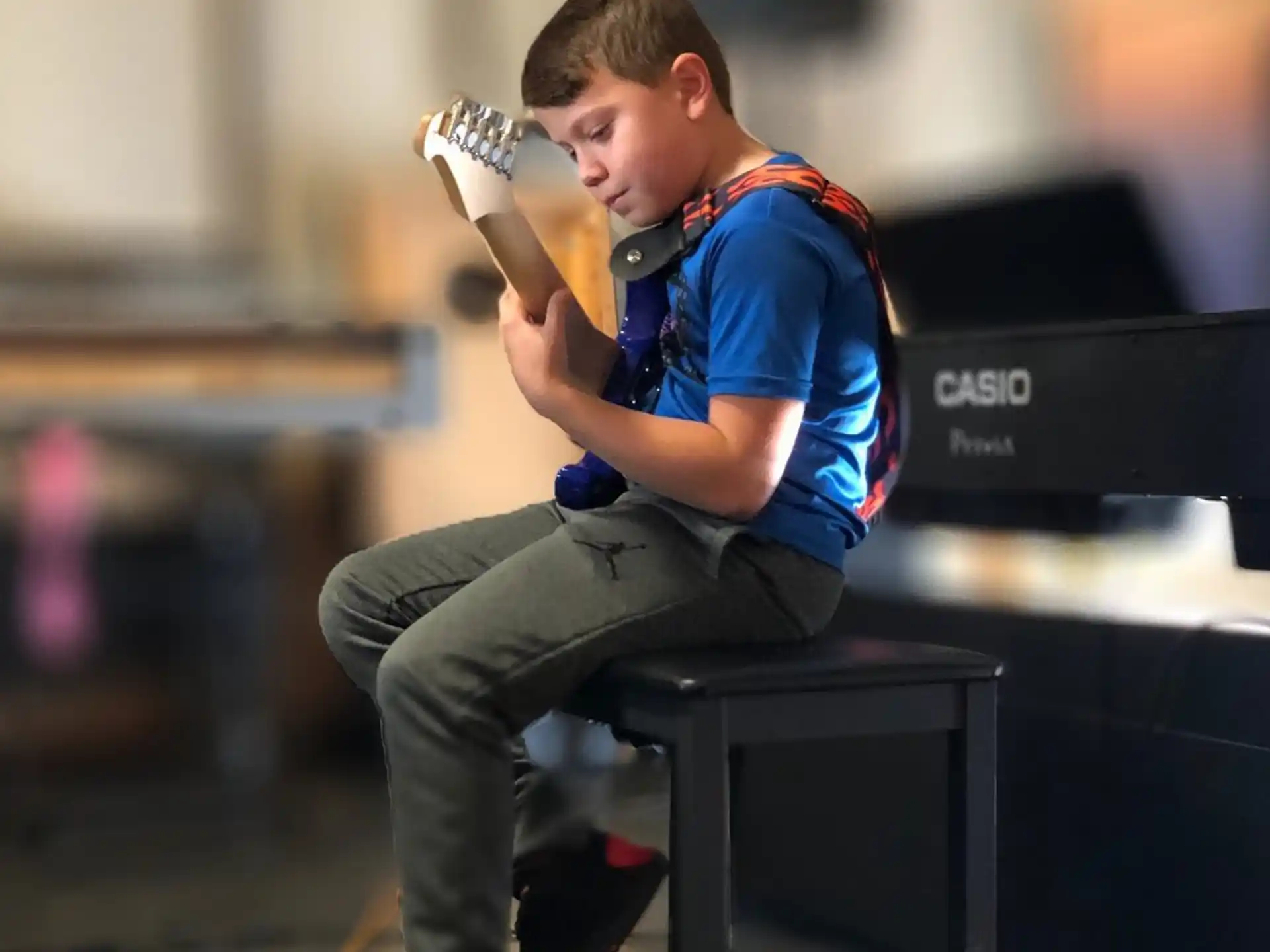 a person sitting on a stool holding a microphone