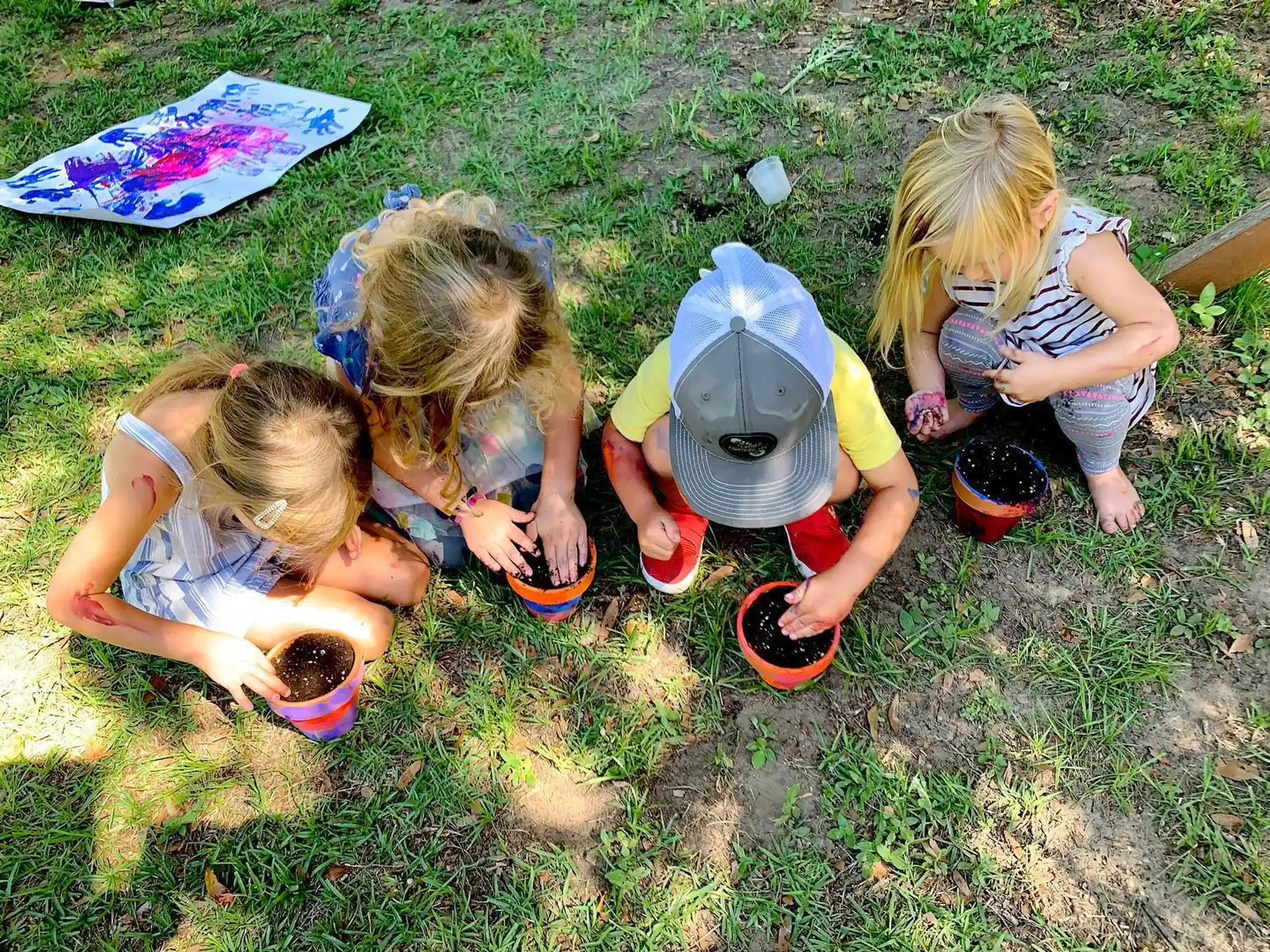 a group of children playing in the grass