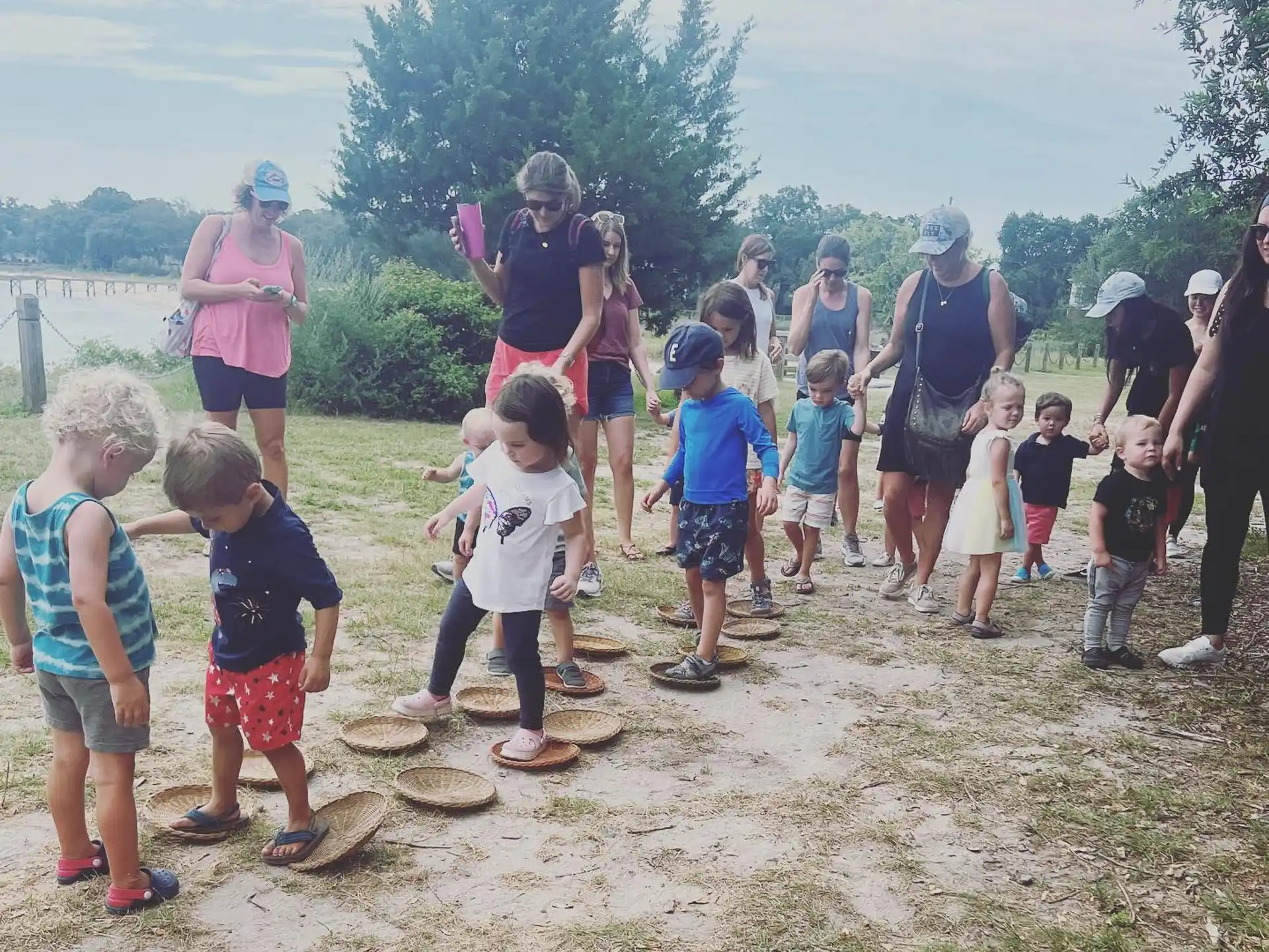 a group of people standing on a dirt hill