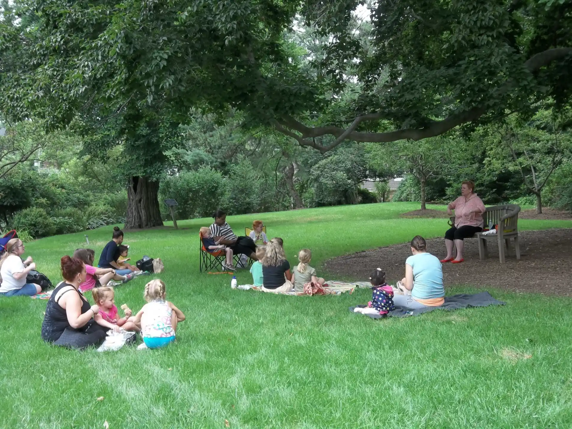 a group of people sitting on the grass