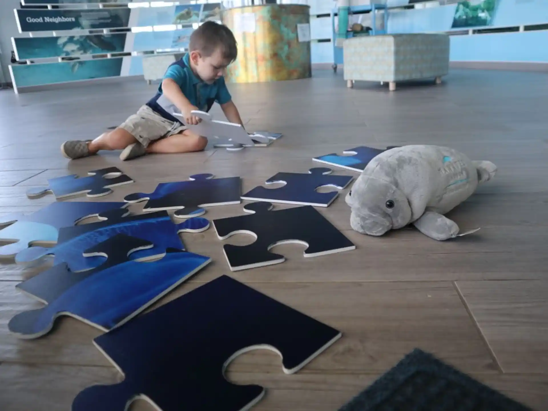 a child sitting on the floor with a toy dinosaur