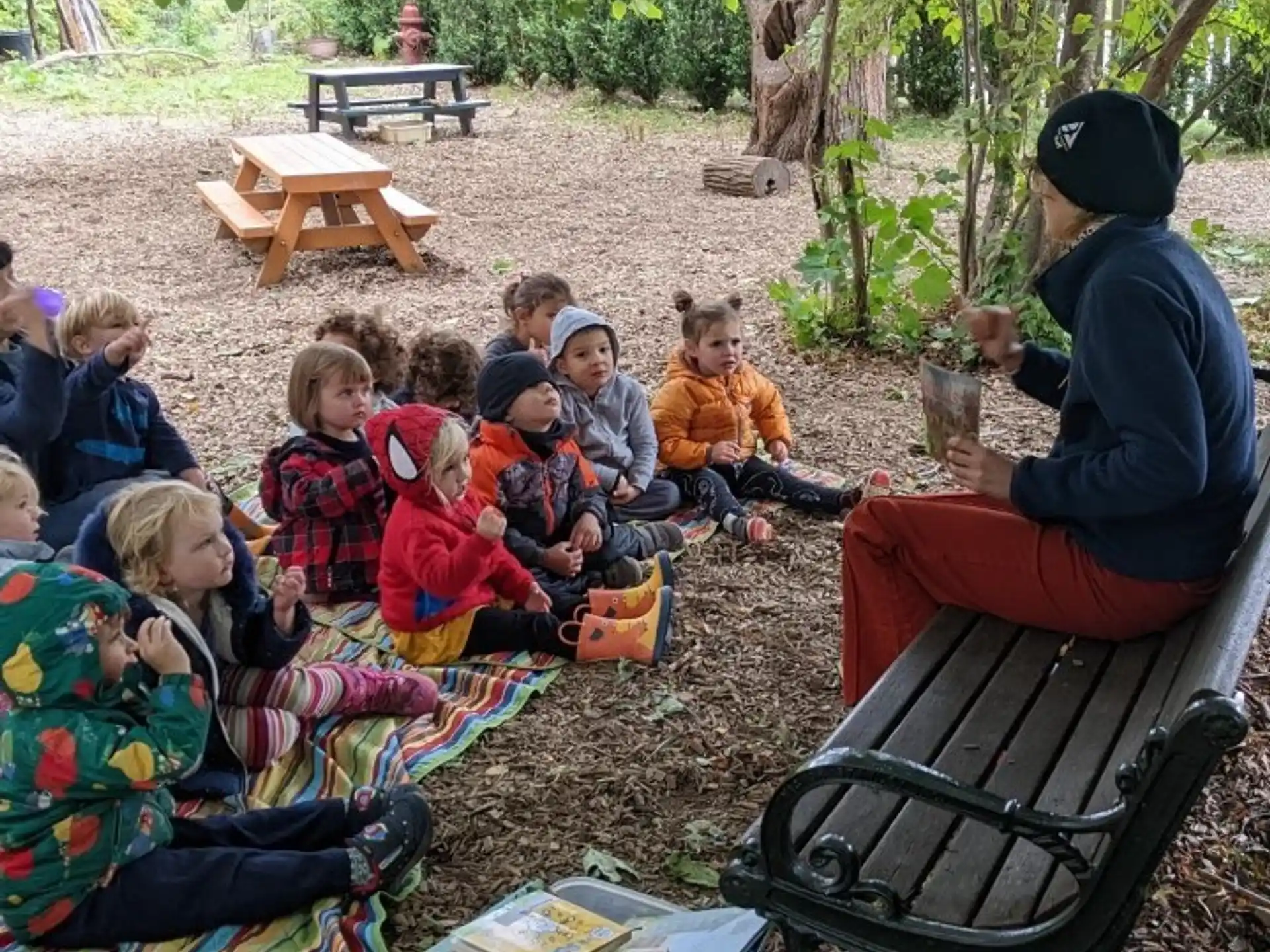 a group of people sitting on the ground outside