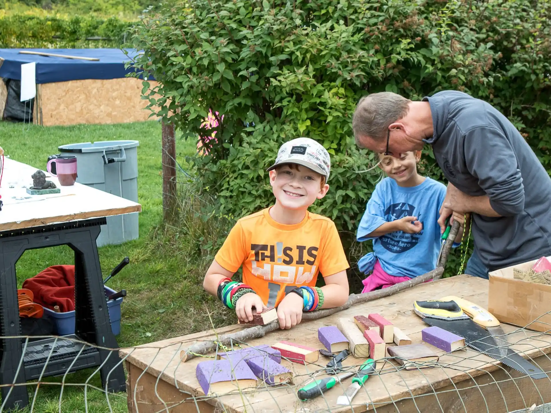 a person and a boy painting outside