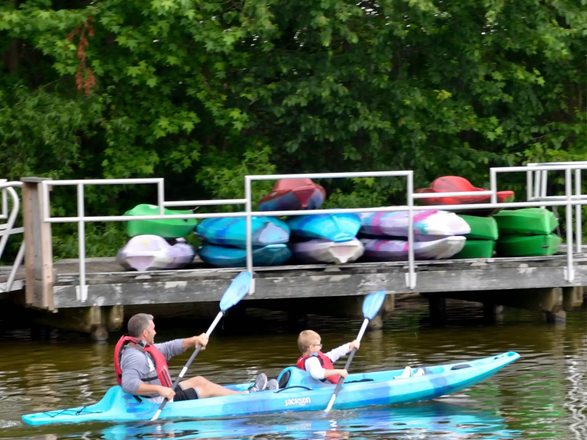 a couple of people in kayaks on a river