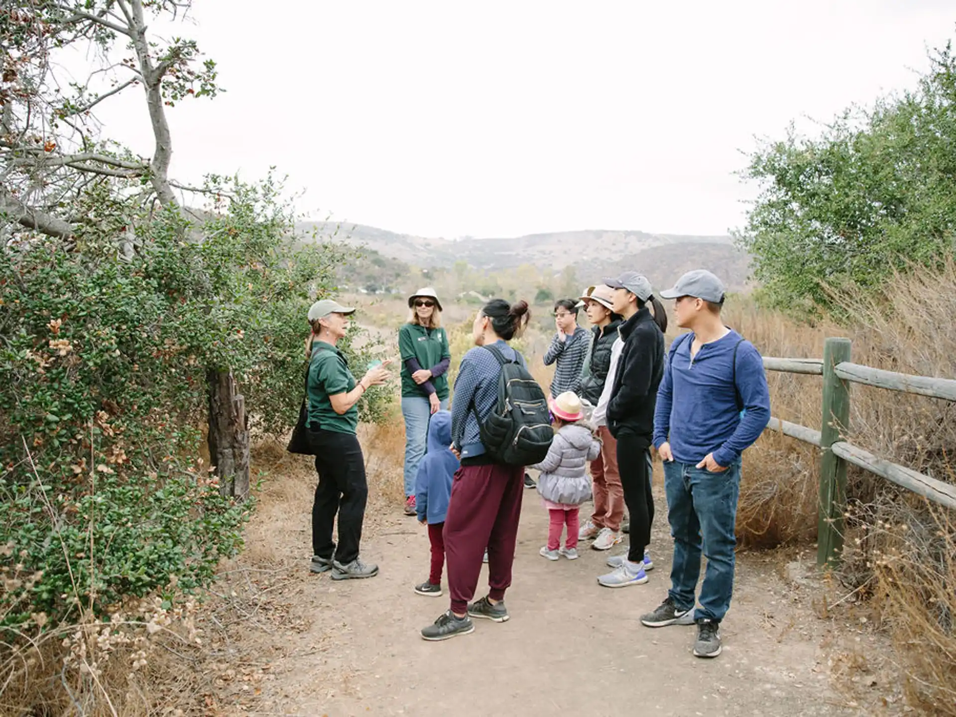 a group of people standing on a path