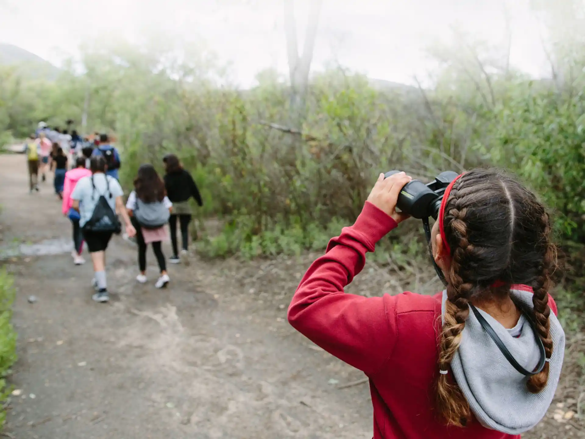 a person taking a picture of people walking on a path
