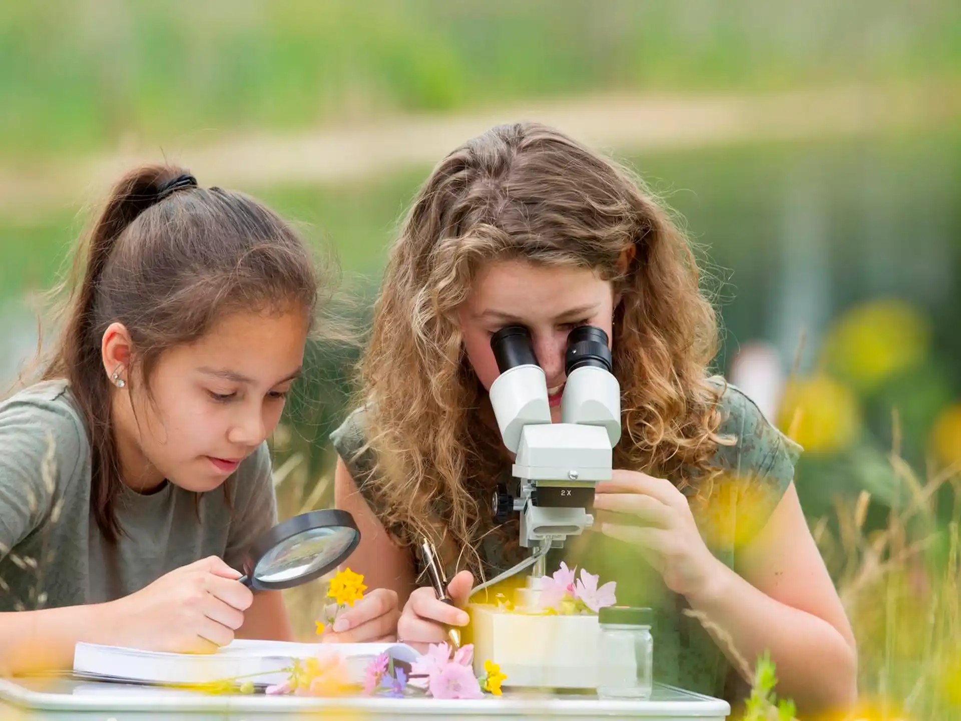 a couple of girls looking at a cake