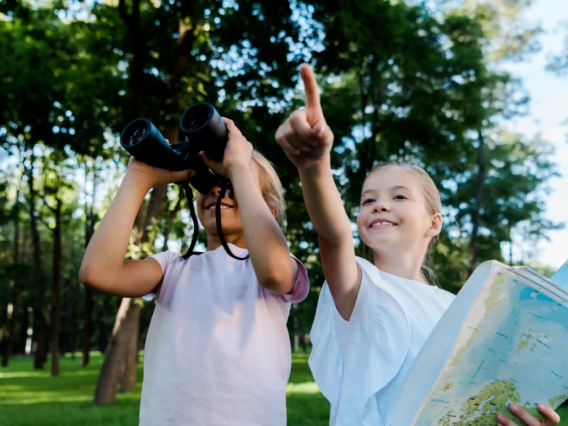 a person holding a camera up to a child with a camera