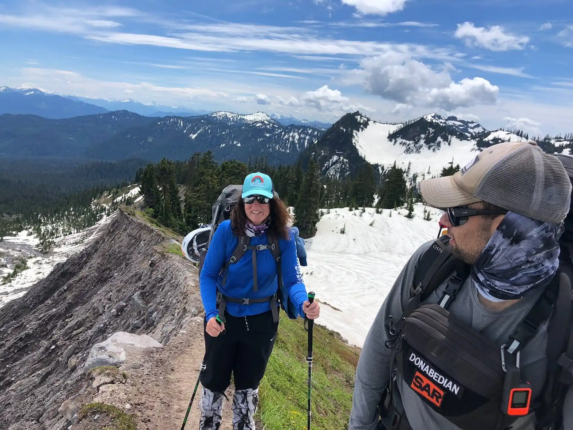 a man and woman on a mountain
