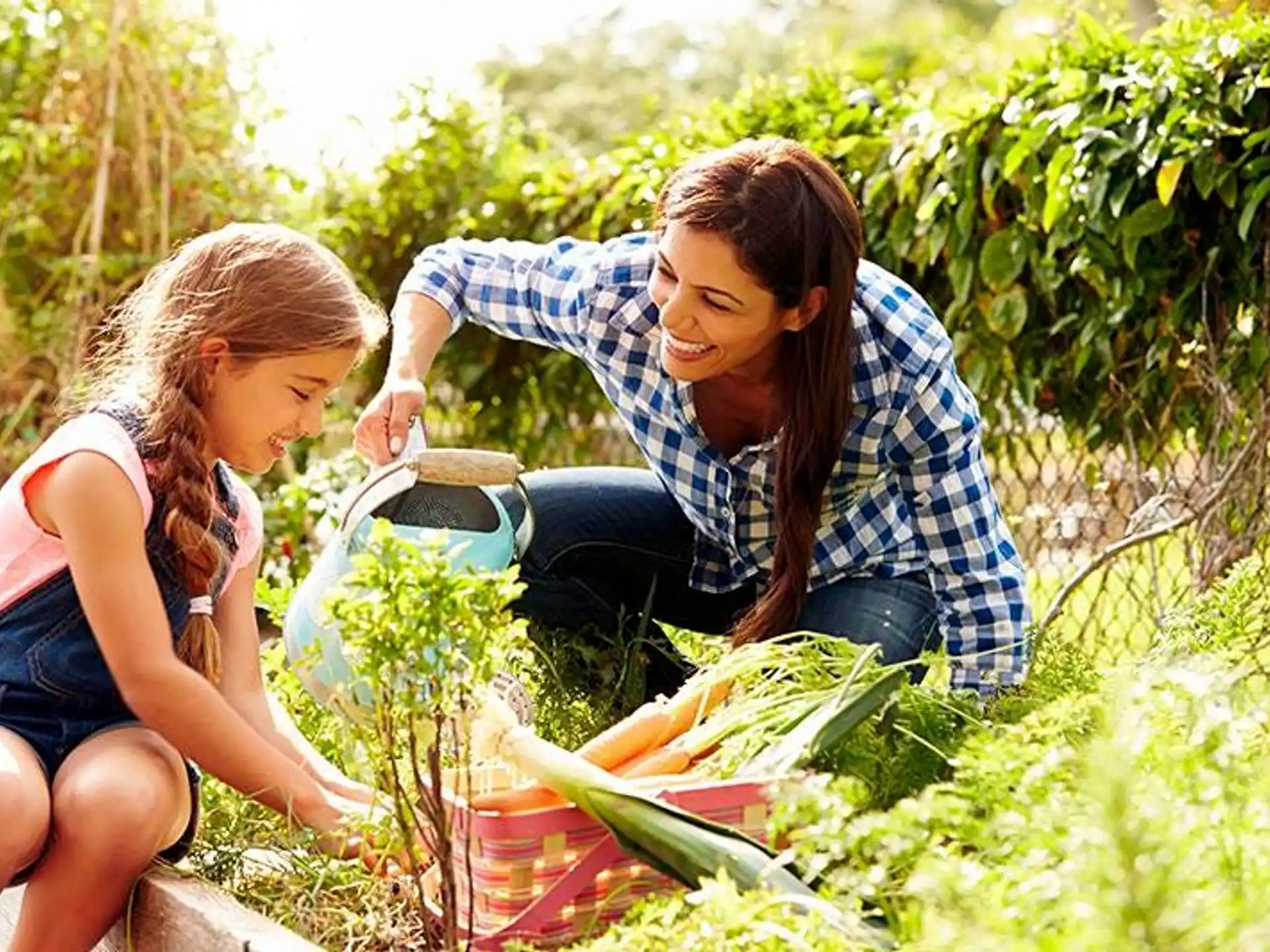 a man and woman holding a basket of vegetables