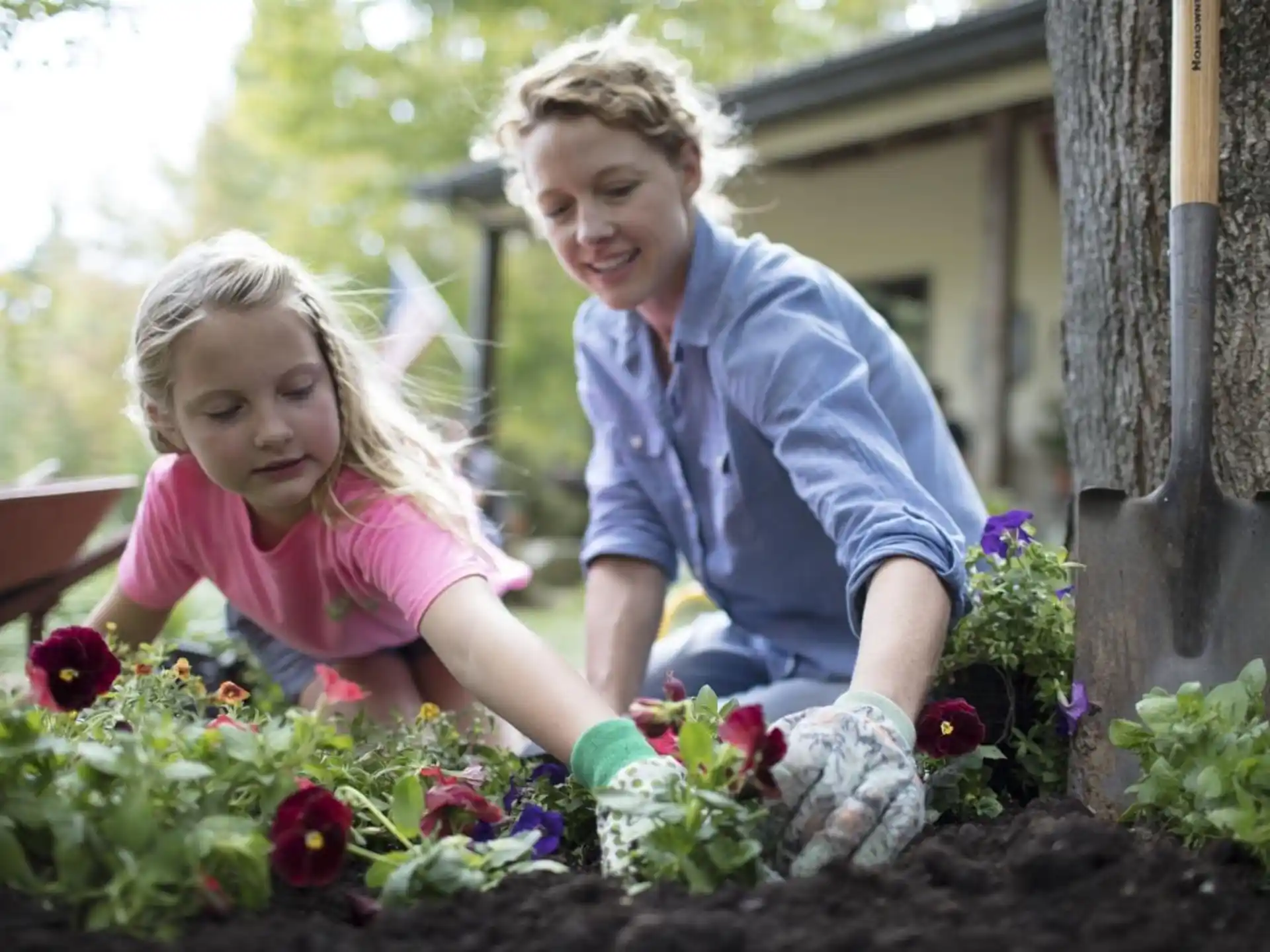 a person and a girl in a garden