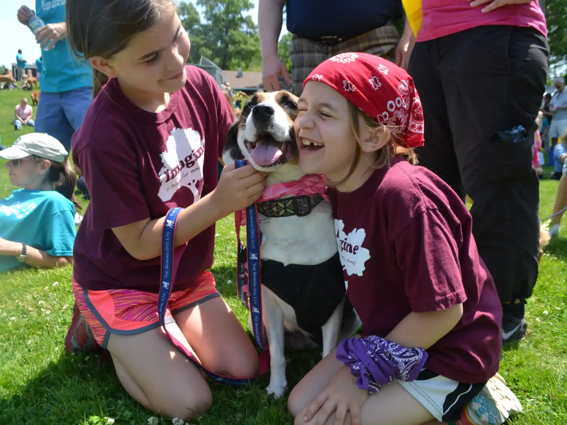 a group of children holding a dog