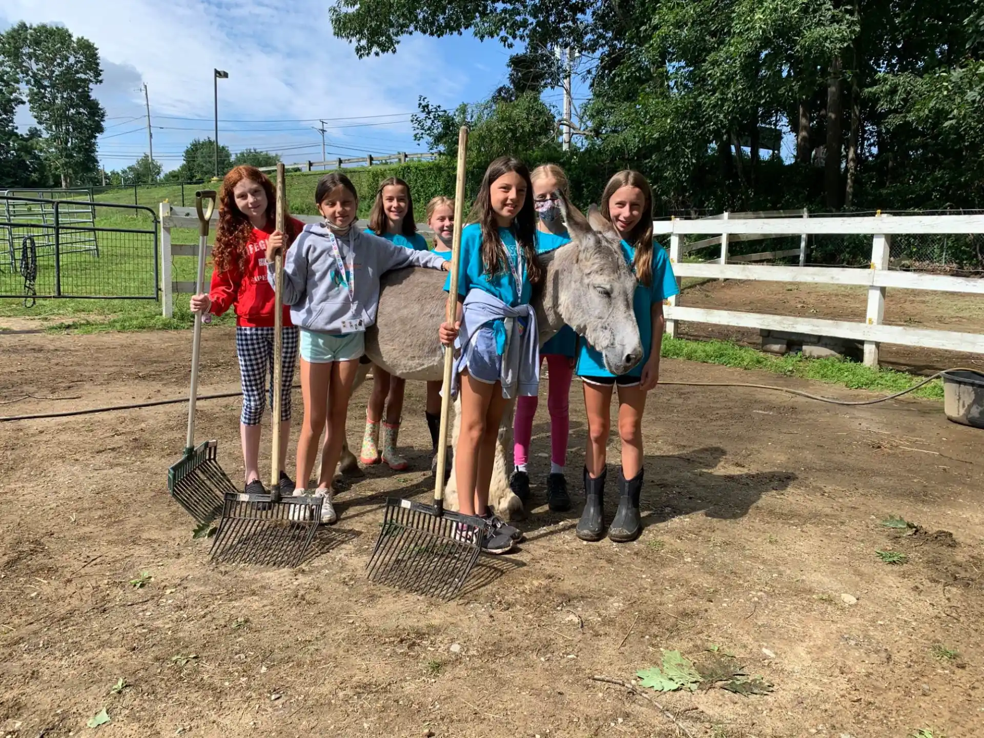 a group of girls holding shovels