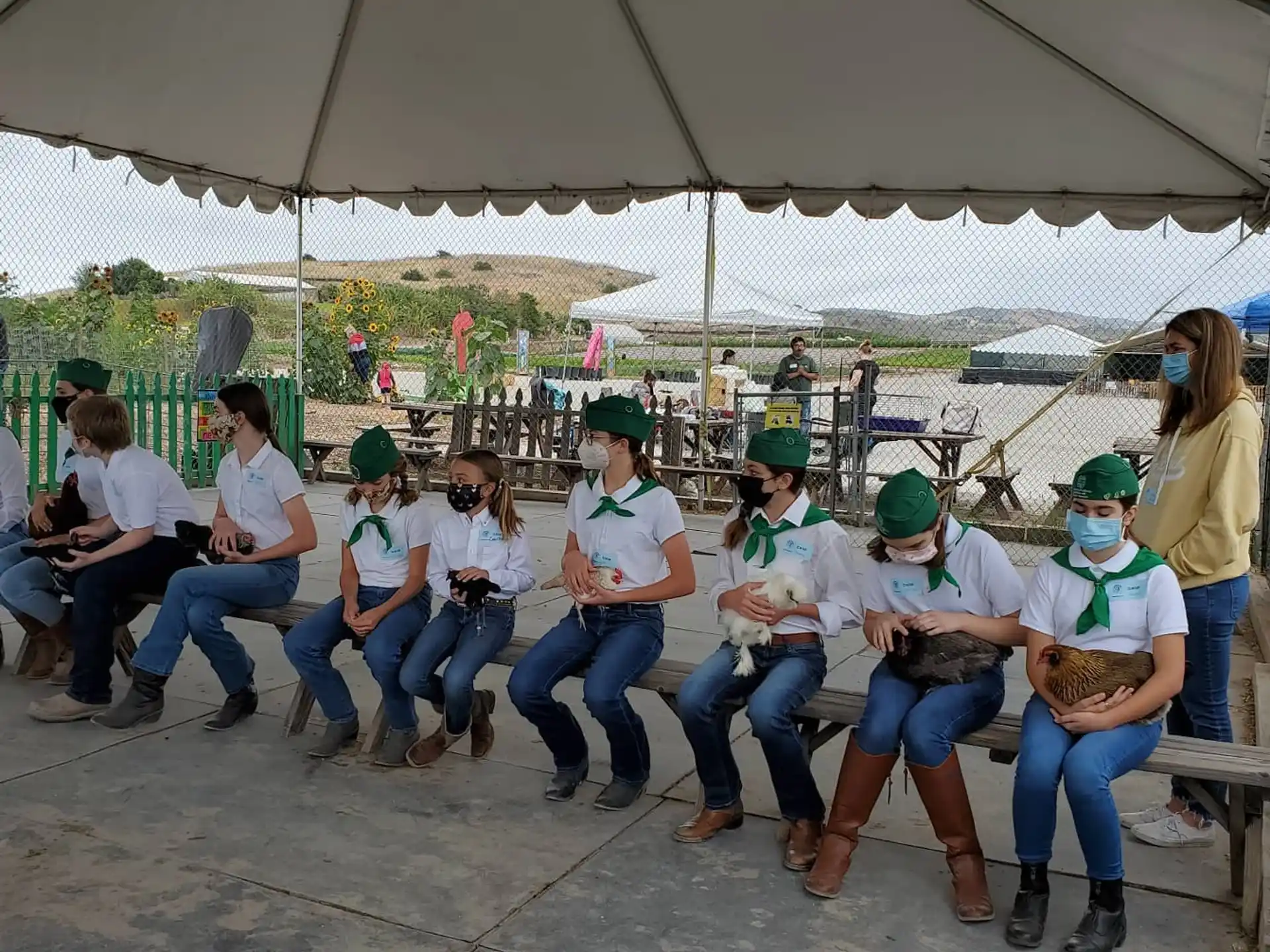 a group of people sitting under a tent