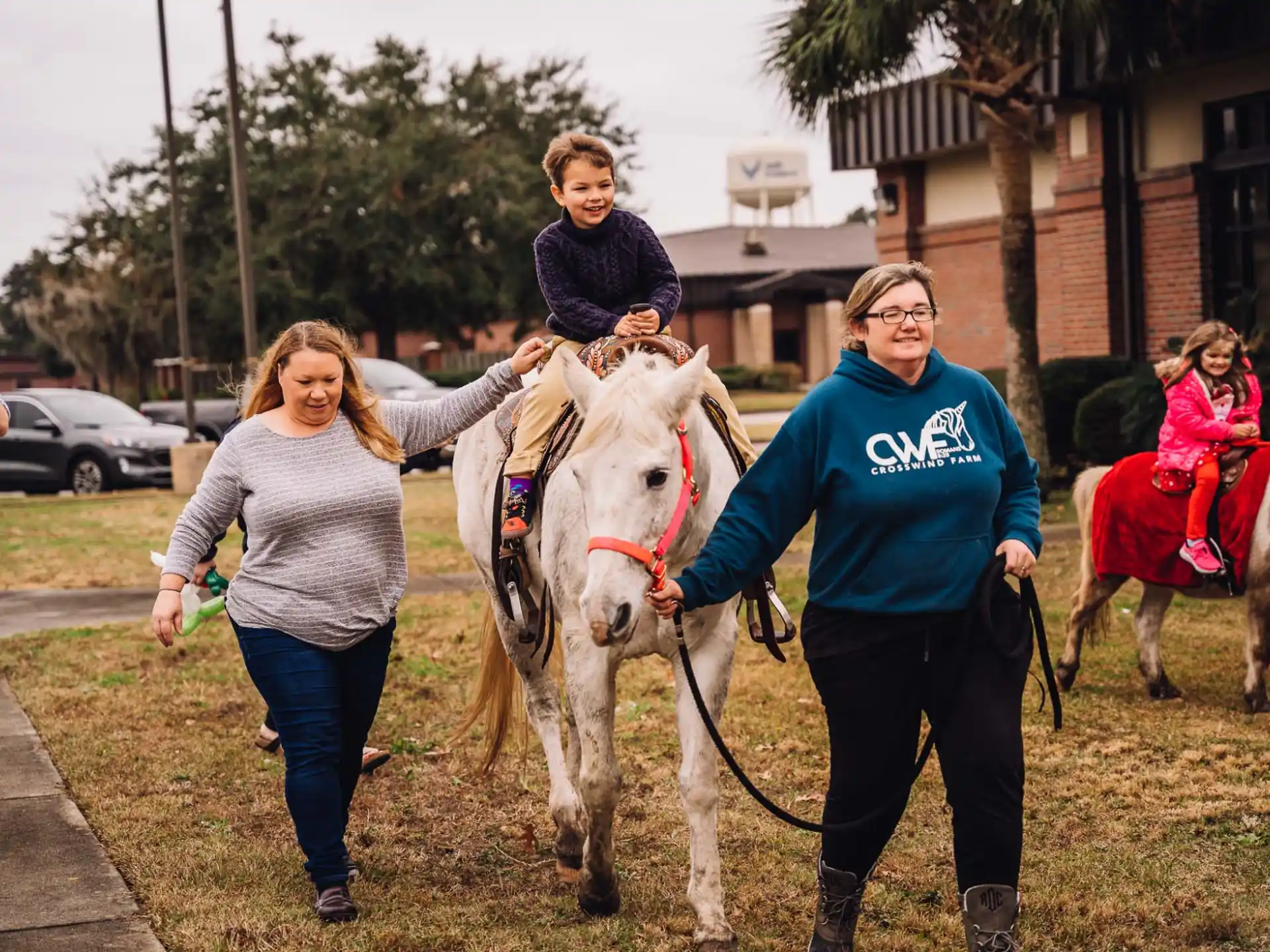 a group of people walking horses