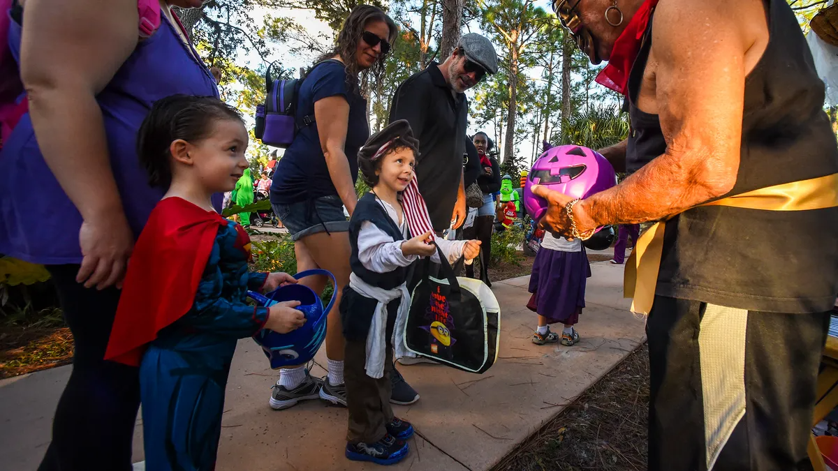 a group of people standing around a person holding a balloon