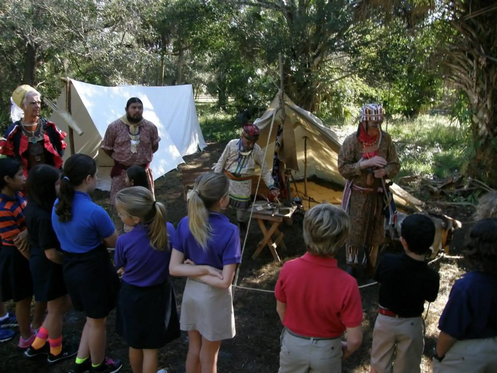 a group of people watching a person play a musical instrument