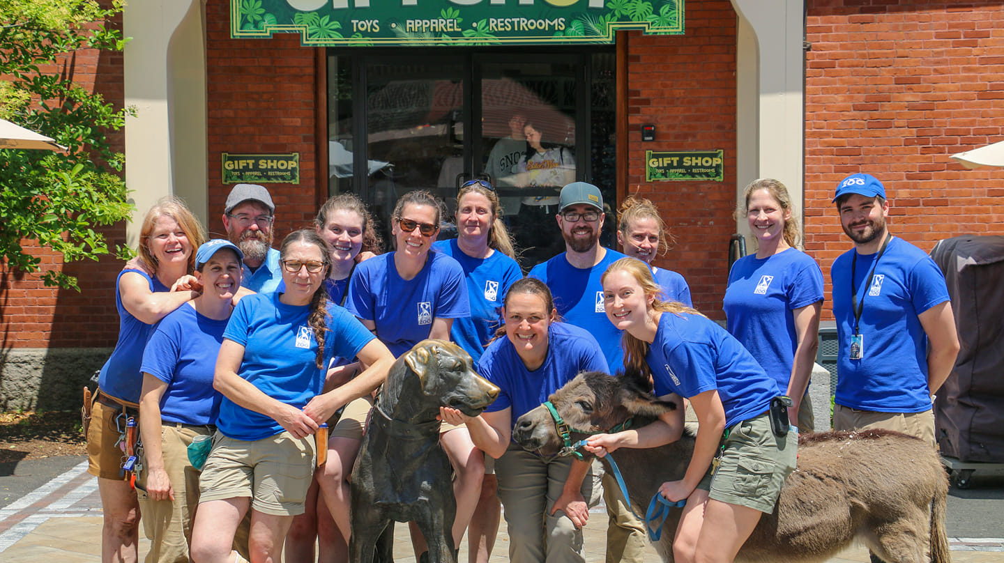 a group of people posing for a photo with a dog