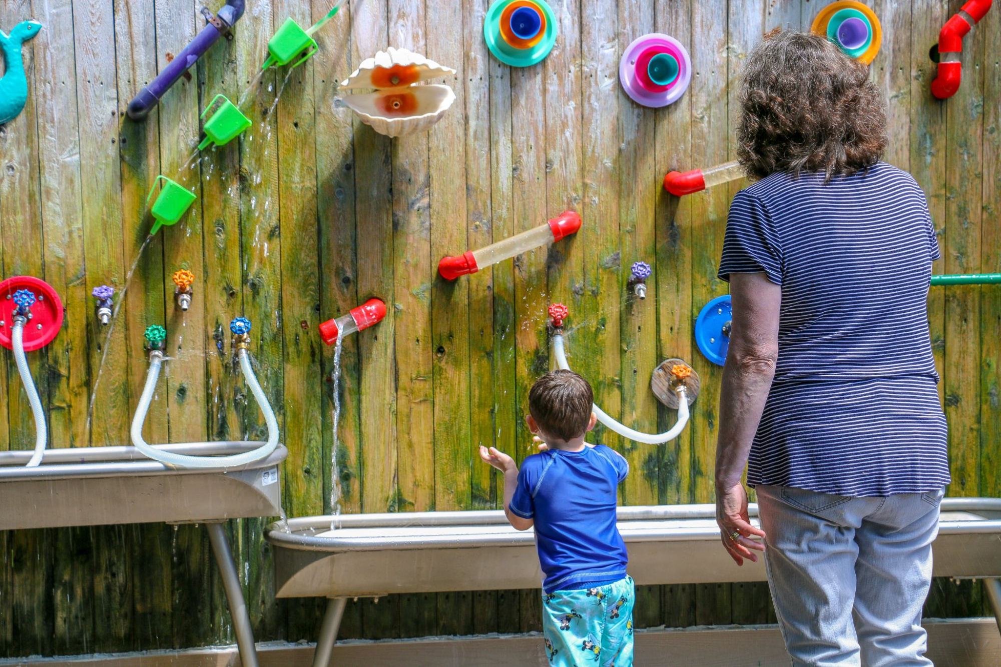 a person and a child playing on a playground