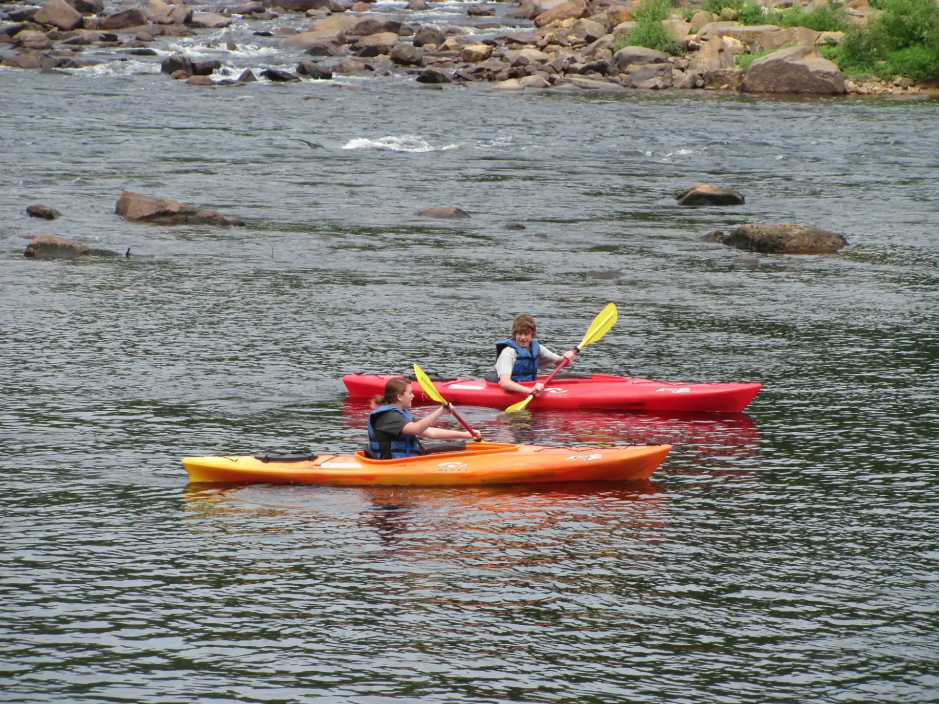a group of people in kayaks on a river
